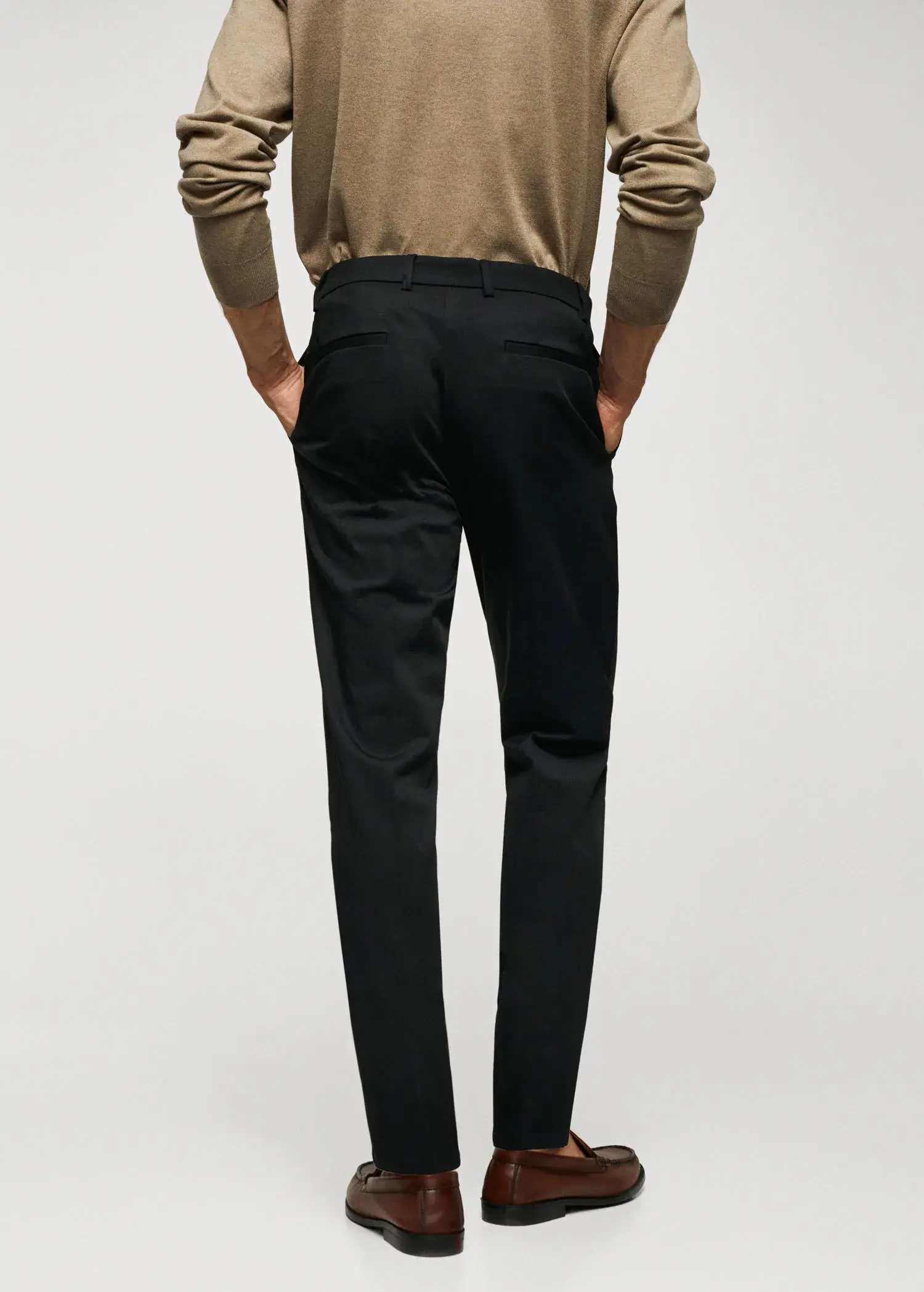 Mango Slim fit chino trousers. a man wearing black pants and a tan shirt. 