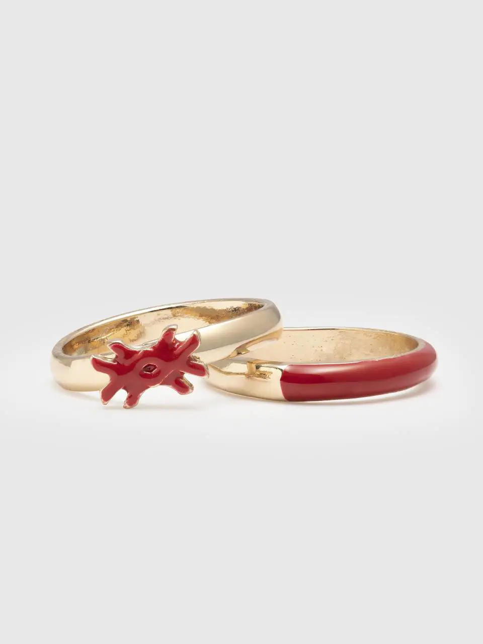 Benetton two rings with coral red enamelled details. 1