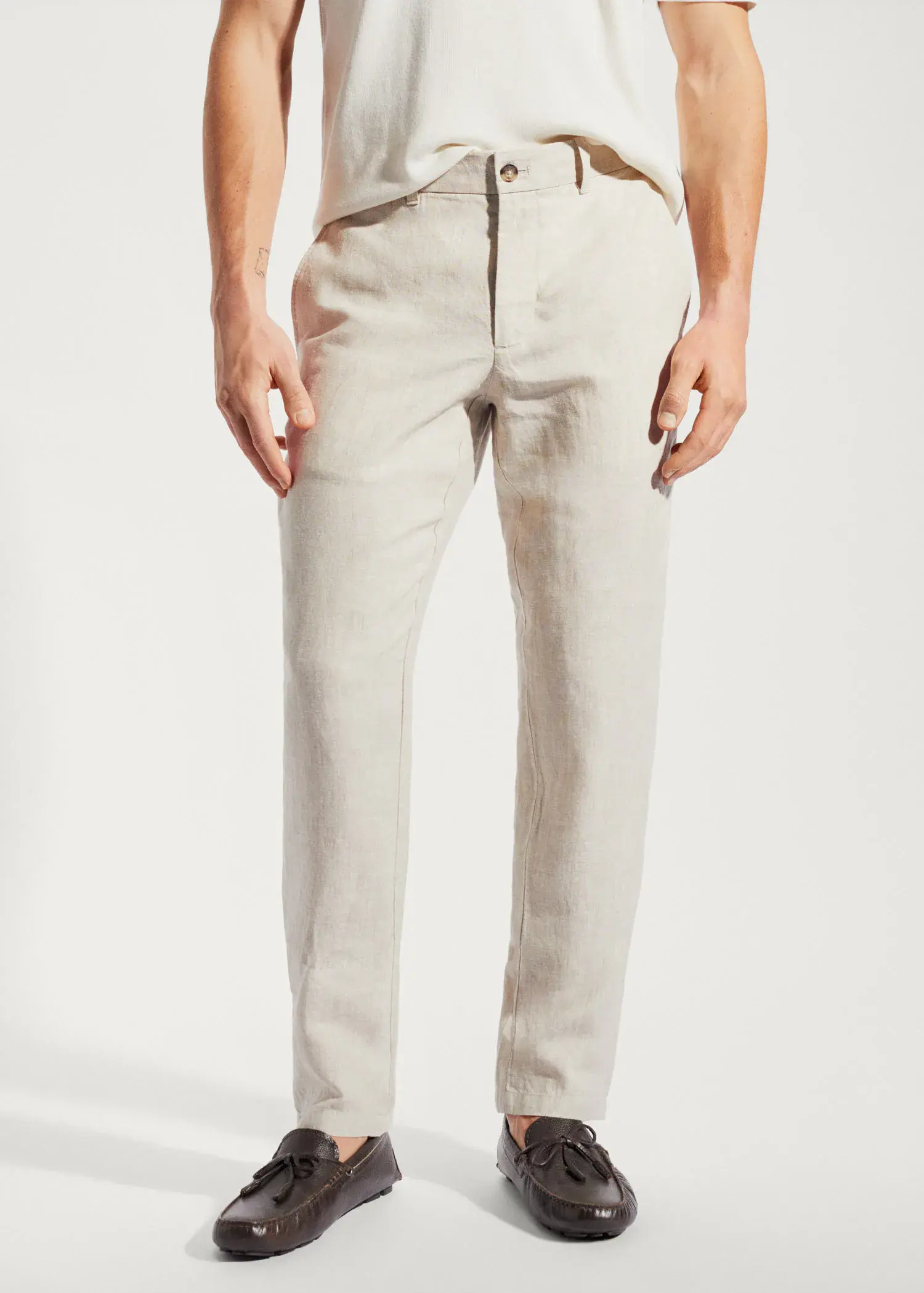 Mango Slim-fit 100% linen pants. a man wearing a pair of white pants. 