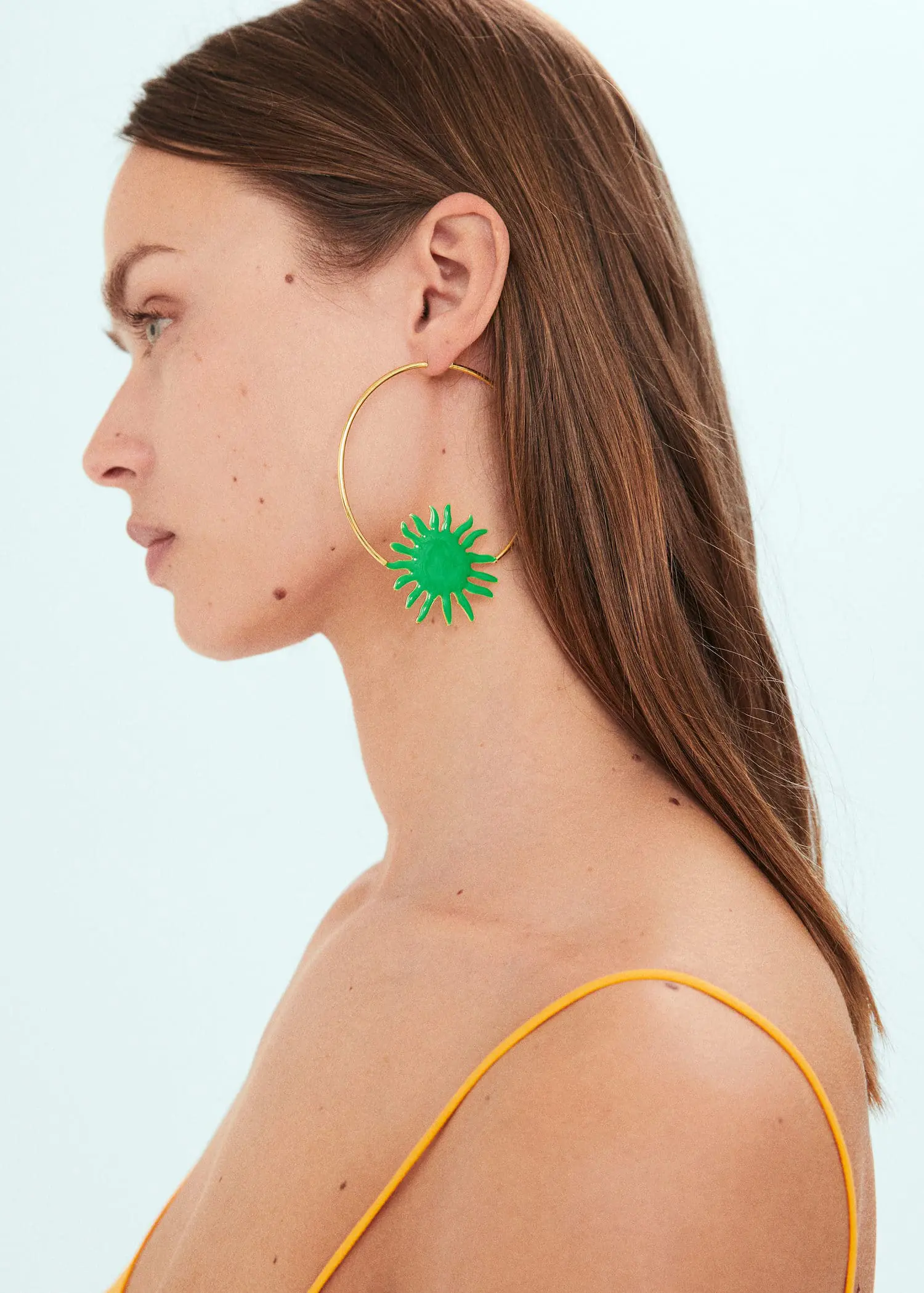 Mango Maxi hoop earrings. a woman wearing a pair of green earrings. 