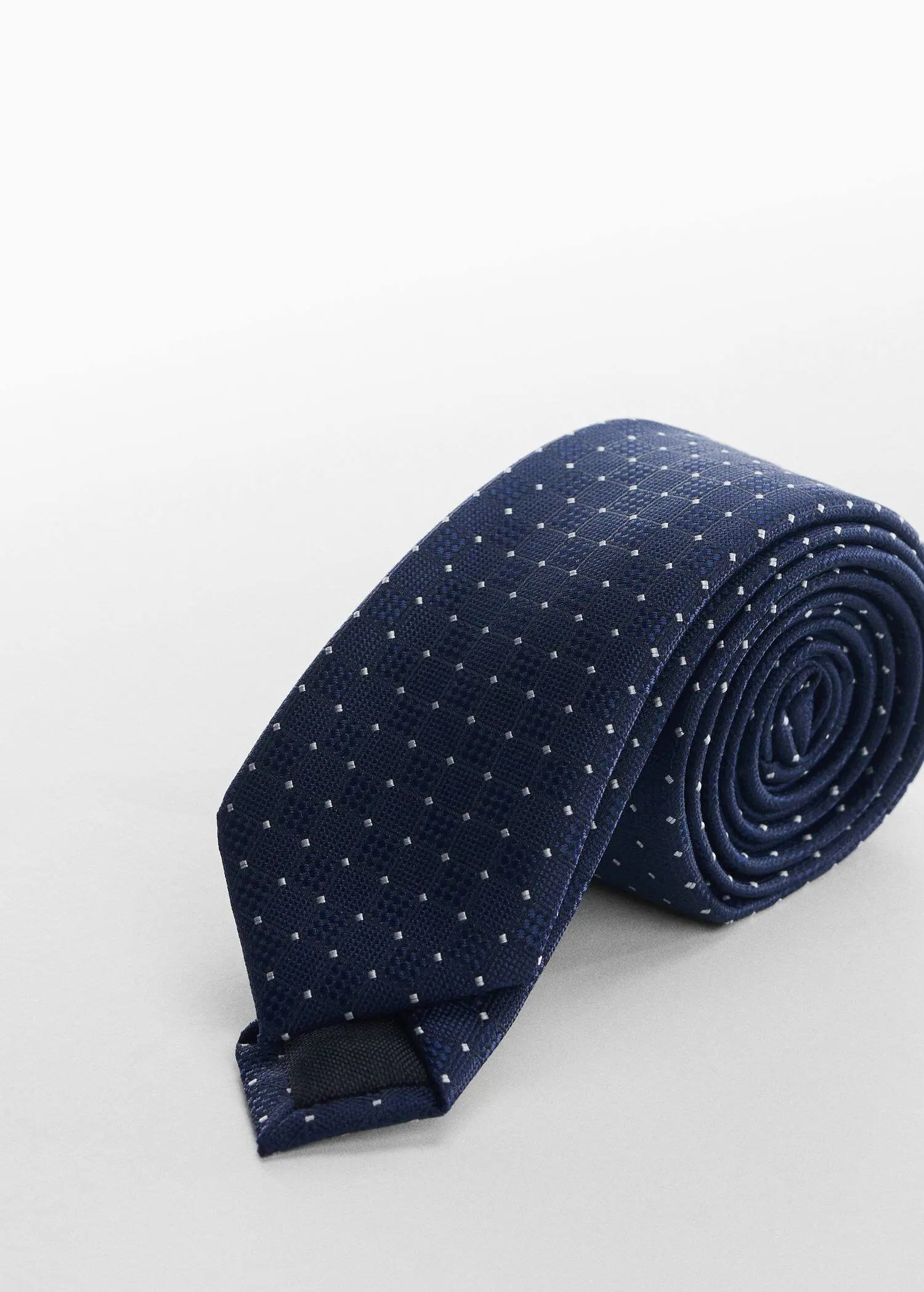 Mango Geometric-structure tie. a tie that is laying on the ground. 