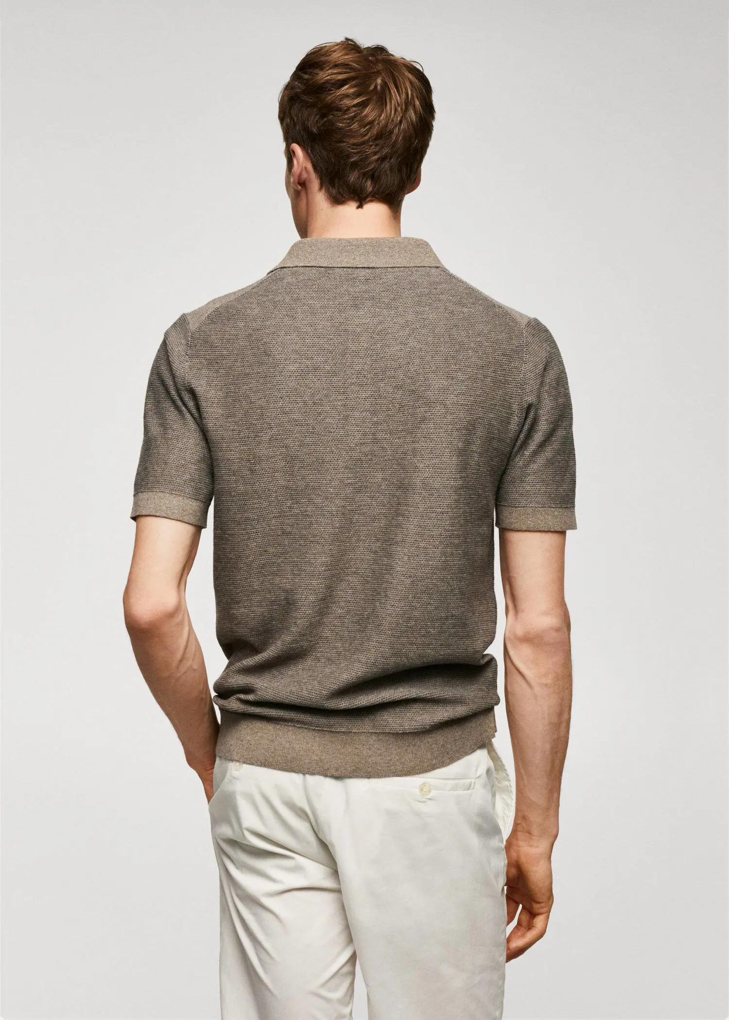 Mango Patterned cotton polo shirt. a man wearing a brown shirt and white pants. 