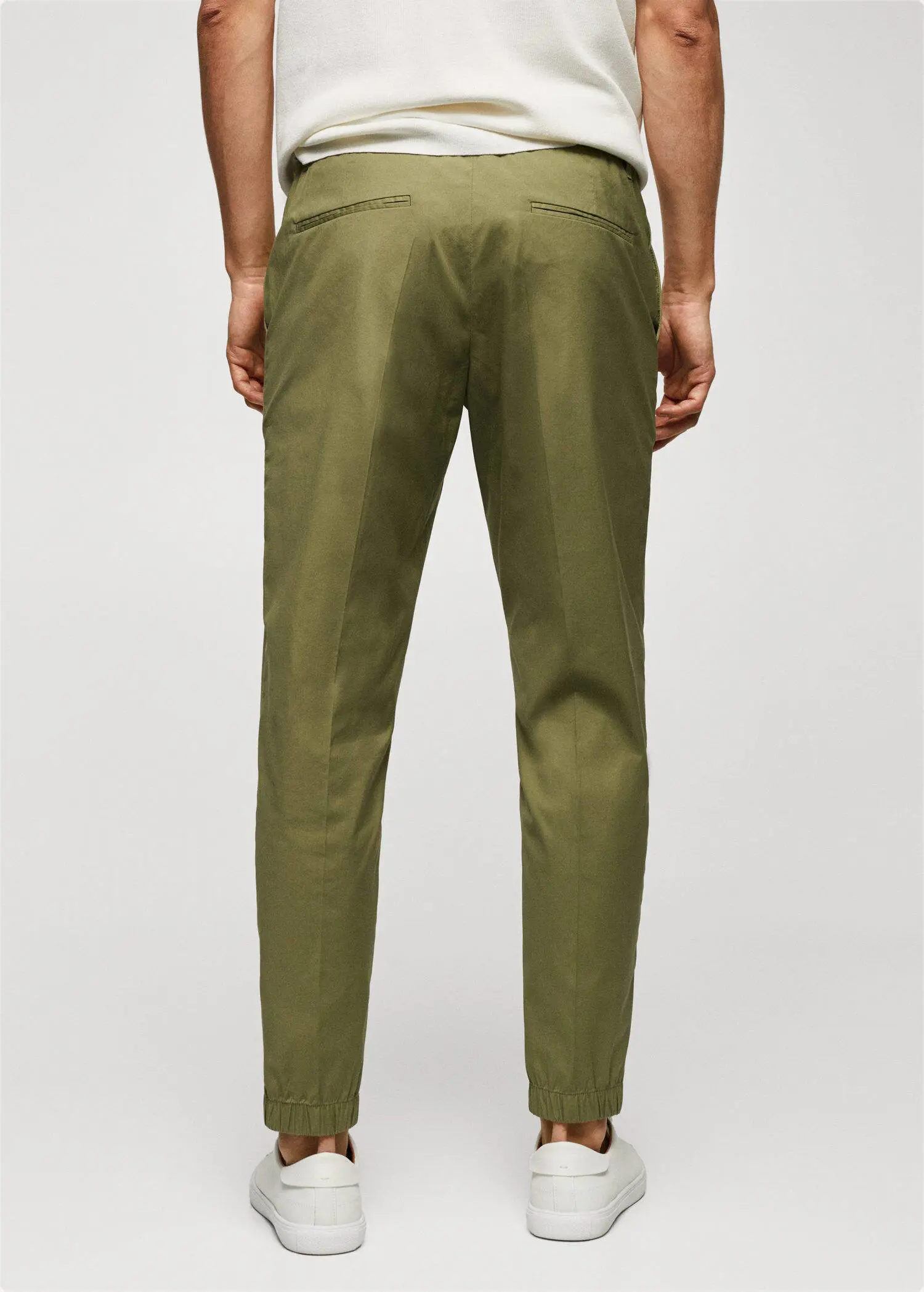 Mango Slim-fit cotton trousers. a person wearing a pair of green pants. 