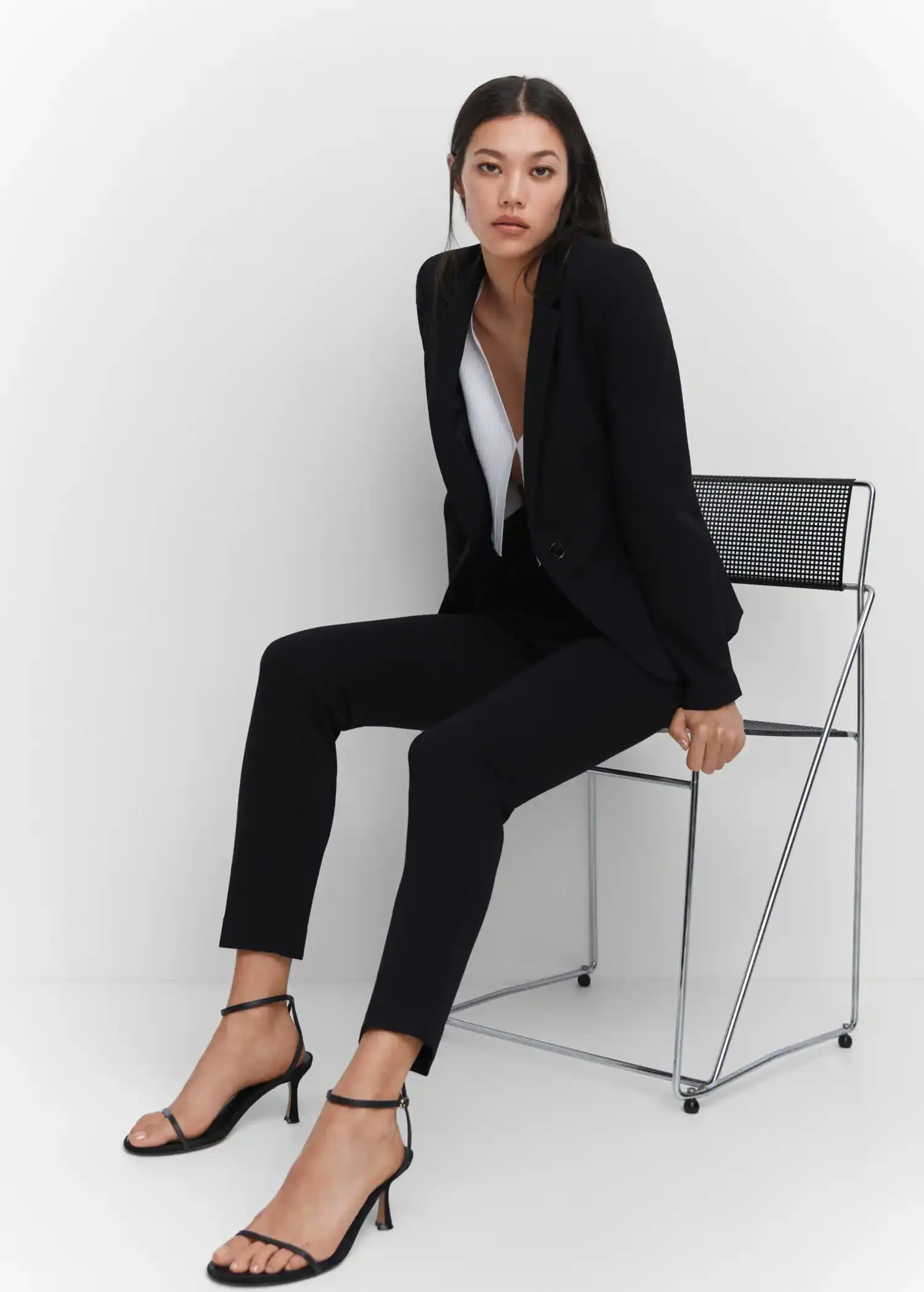 Mango Rome-knit straight trousers. a woman sitting on top of a chair wearing a suit. 
