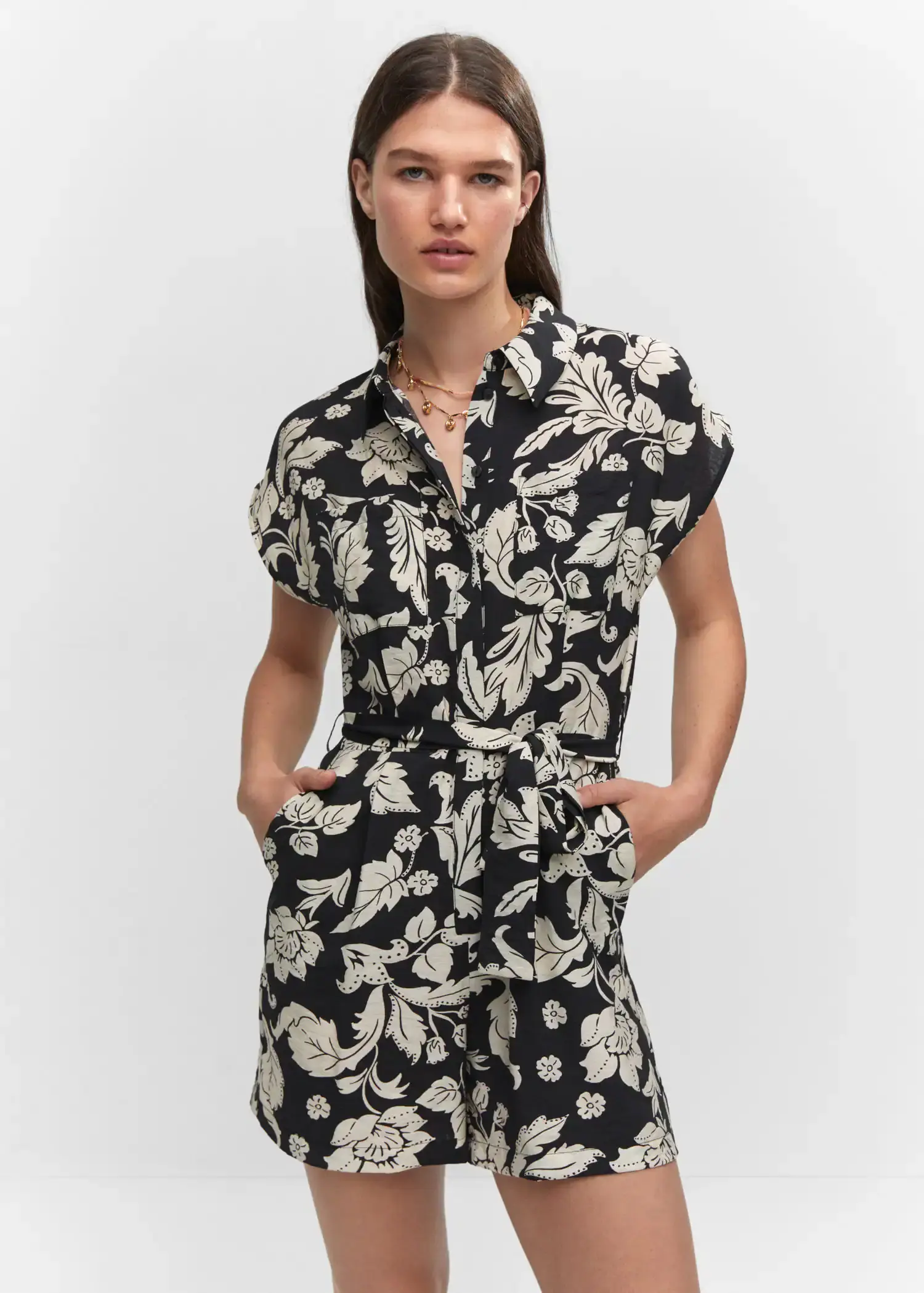 Mango Floral-print jumpsuit with tie. a woman in a black and white floral dress. 