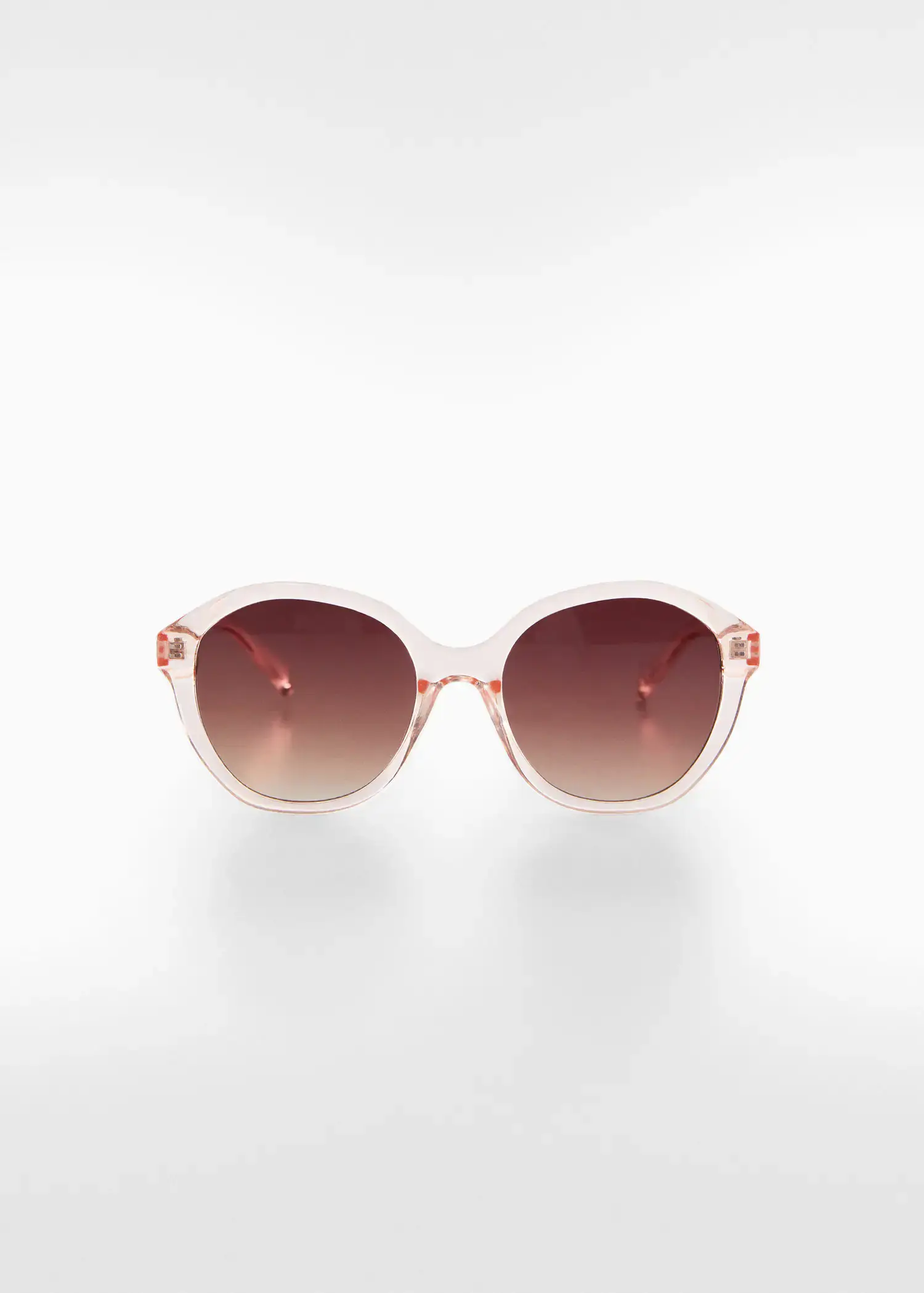 Mango Tortoiseshell rounded sunglasses. a pair of sunglasses sitting on top of a white table. 