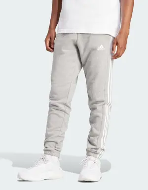 Adidas Pantalon fuselé en molleton aux chevilles élastiques et à 3 bandes Essentials