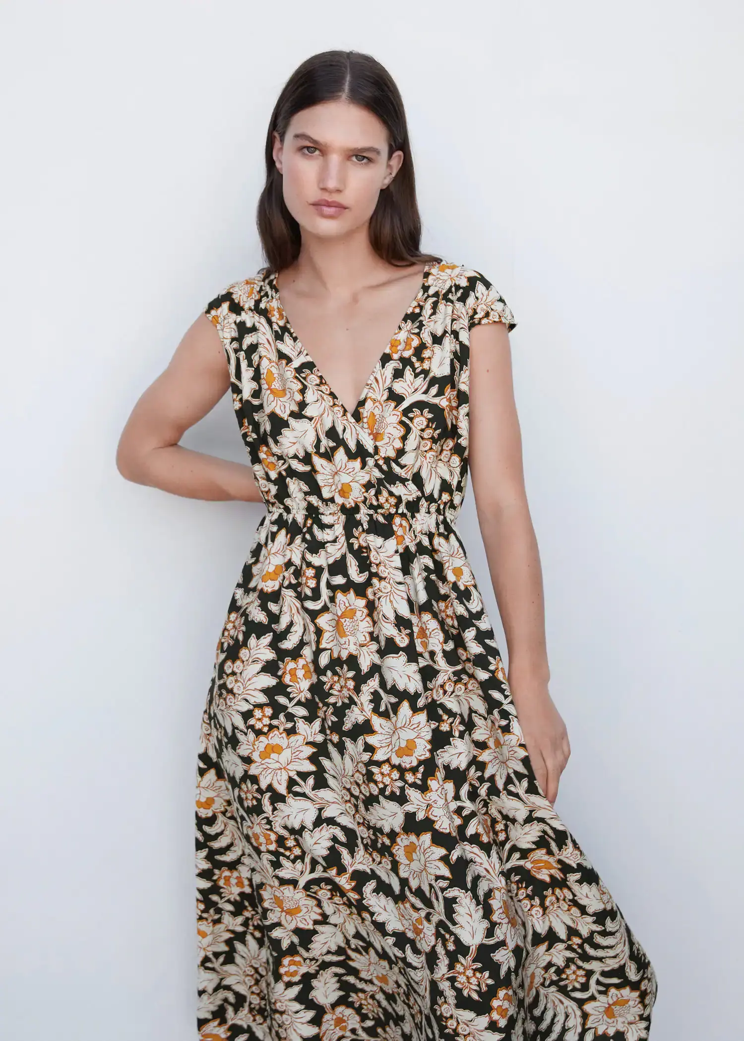Mango Floral wrap neckline dress. a woman in a floral dress posing for a picture. 