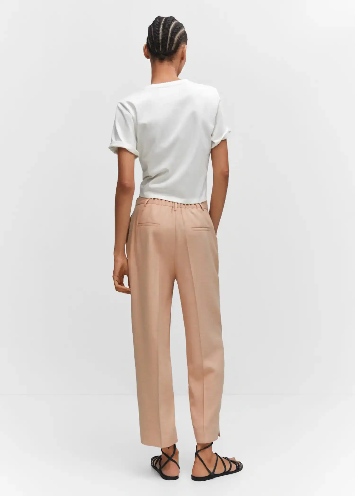 Mango Pleat straight trousers. a person standing in front of a white wall. 