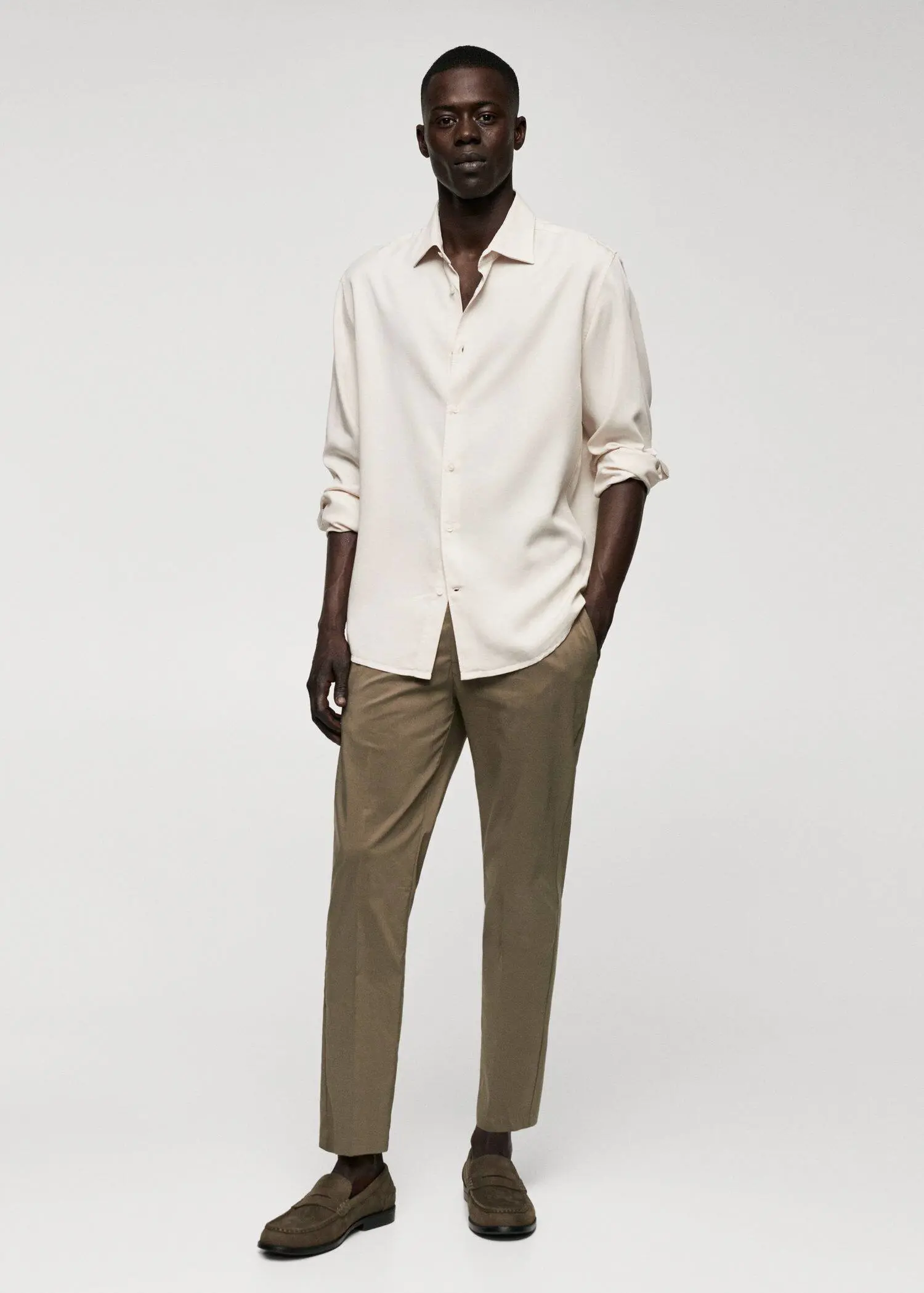 Mango Lyocell fluid shirt. a man wearing a white shirt and brown pants. 