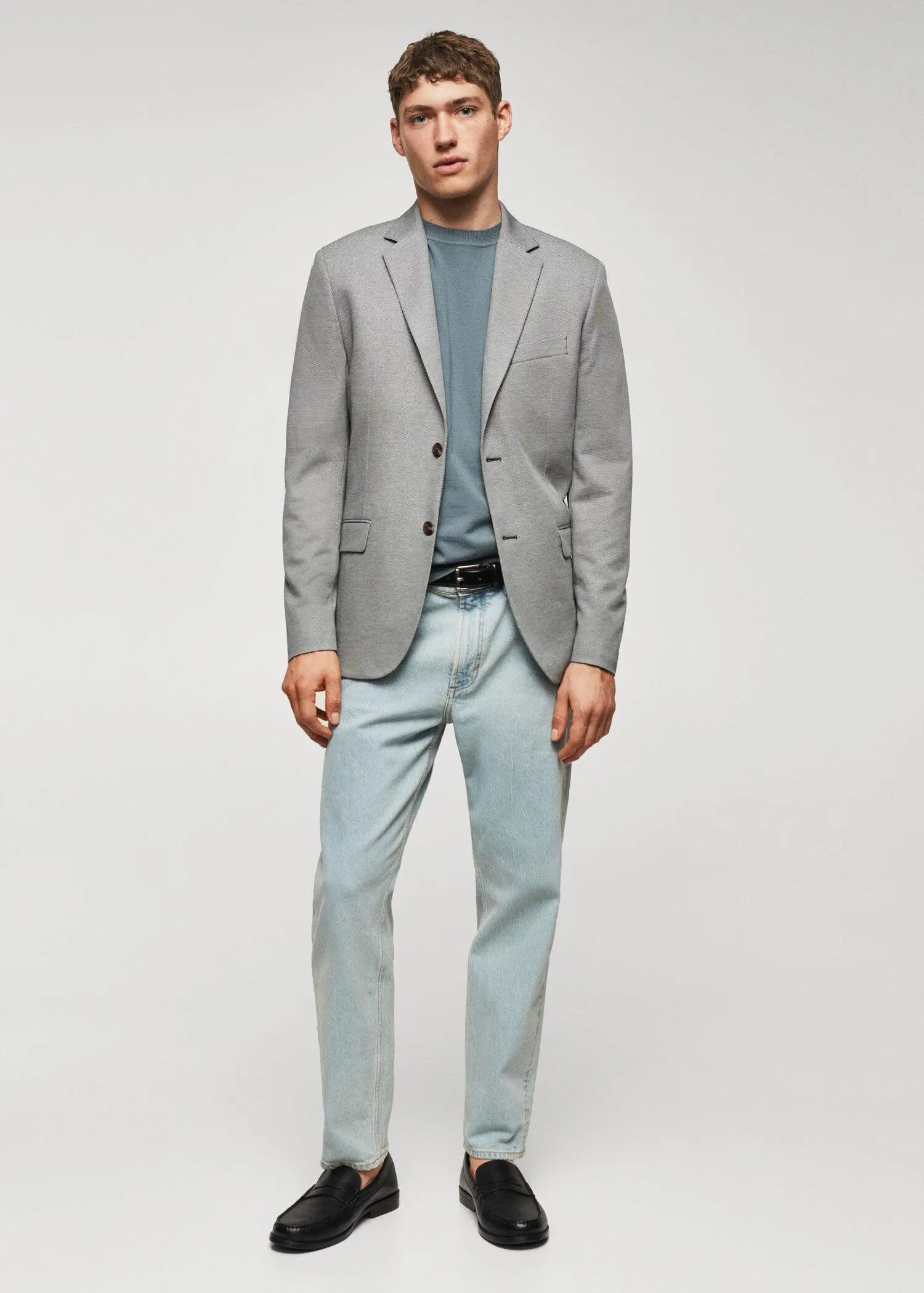 Mango Slim fit microstructure blazer. a man wearing a gray jacket and light blue pants. 