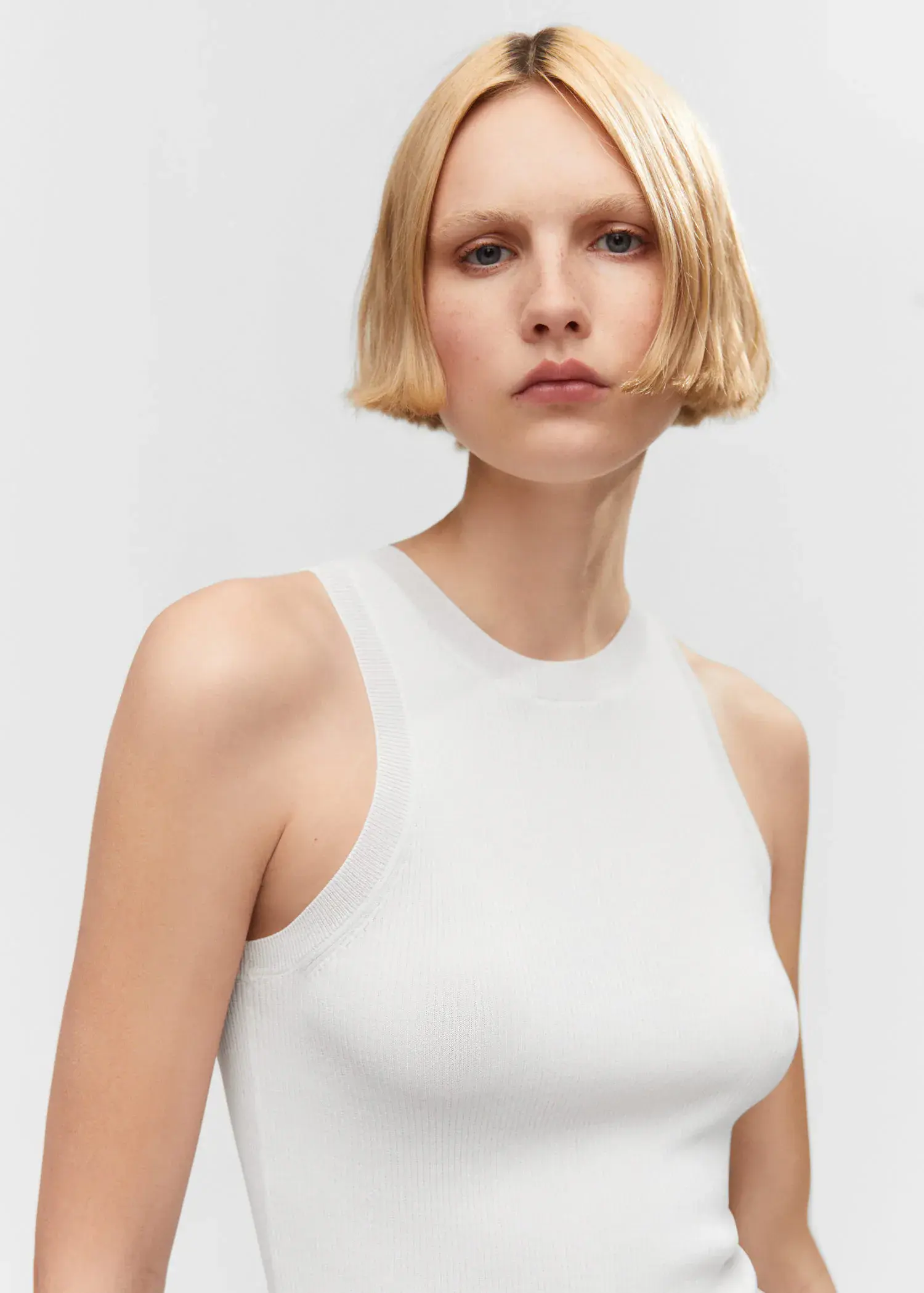 Mango Ribbed knit top. a woman with short blonde hair wearing a white top. 
