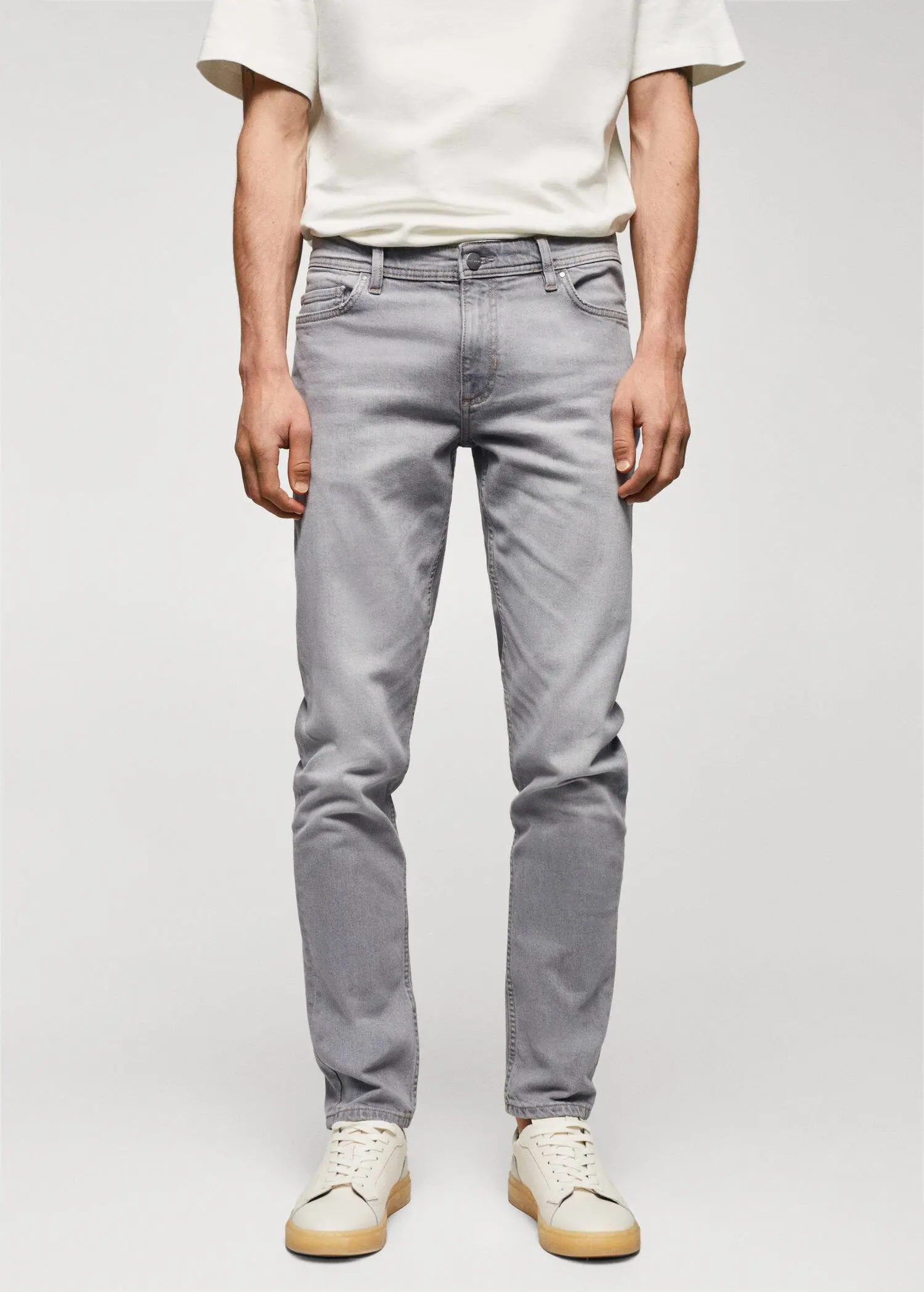 Mango Jan slim-fit jeans. a man wearing grey pants and a white shirt. 