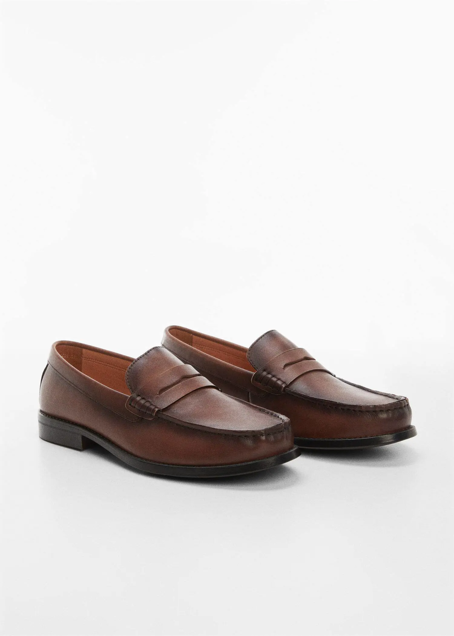 Mango Leather penny loafers. a pair of brown loafers on top of a white surface. 