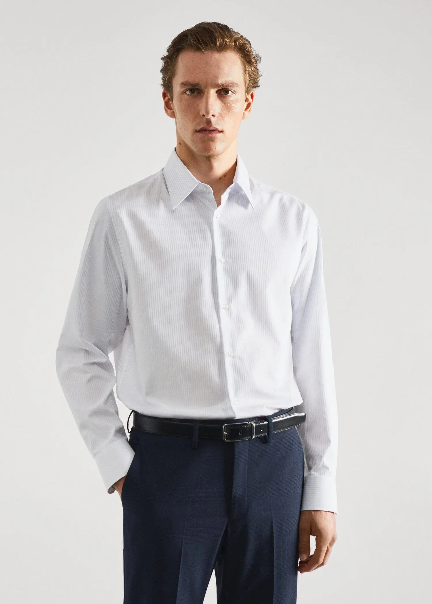 Mango Slim-fit striped cotton twill suit shirt. a man in a white shirt and black belt. 