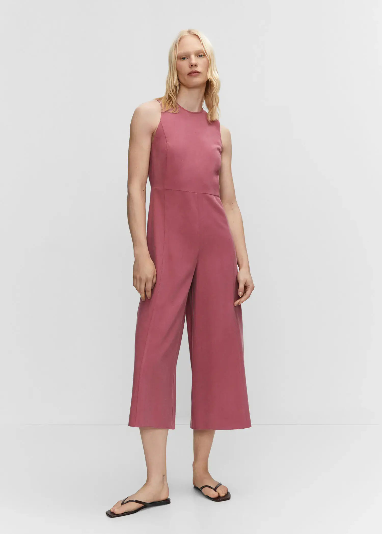 Mango Cropped jumpsuit with straps. a woman wearing a pink jumpsuit standing in front of a white wall. 