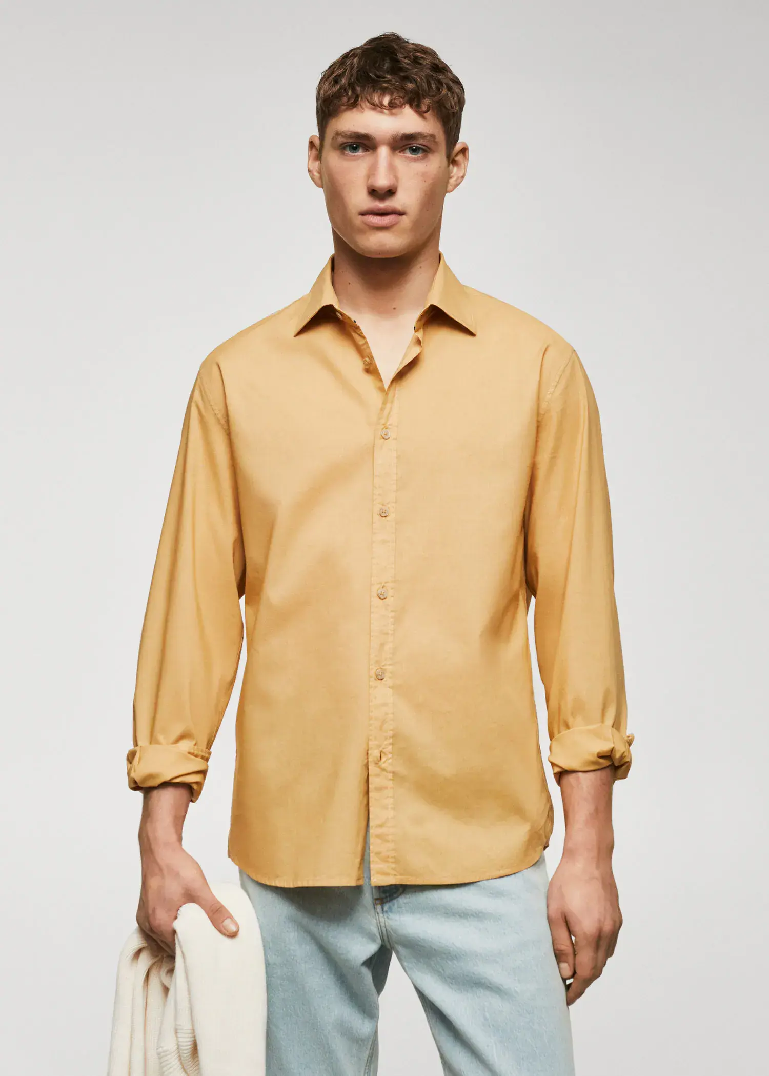Mango Regular-fit cotton voile shirt. a man in a yellow shirt is holding his arm. 