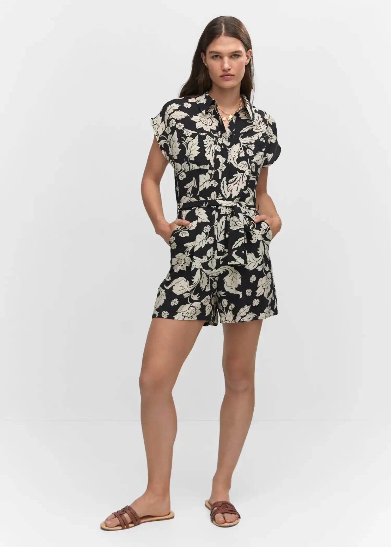 Mango Floral-print jumpsuit with tie. a woman in a black and white floral dress. 