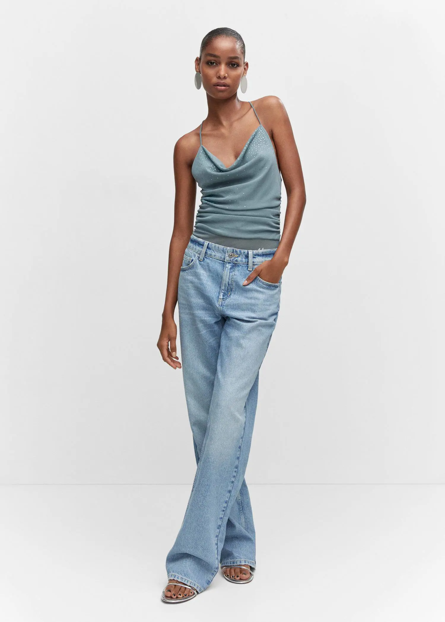 Mango Shiny straight-leg jeans. a woman wearing a blue top and jeans. 