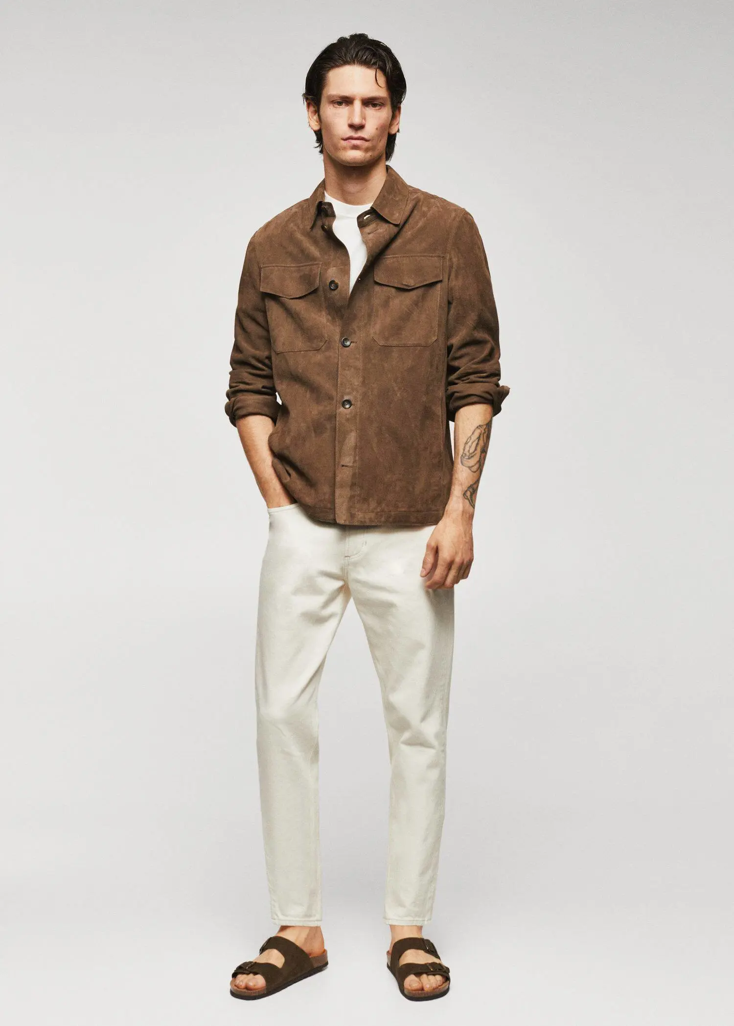 Mango 100% suede leather jacket. a man wearing a brown jacket and white pants. 