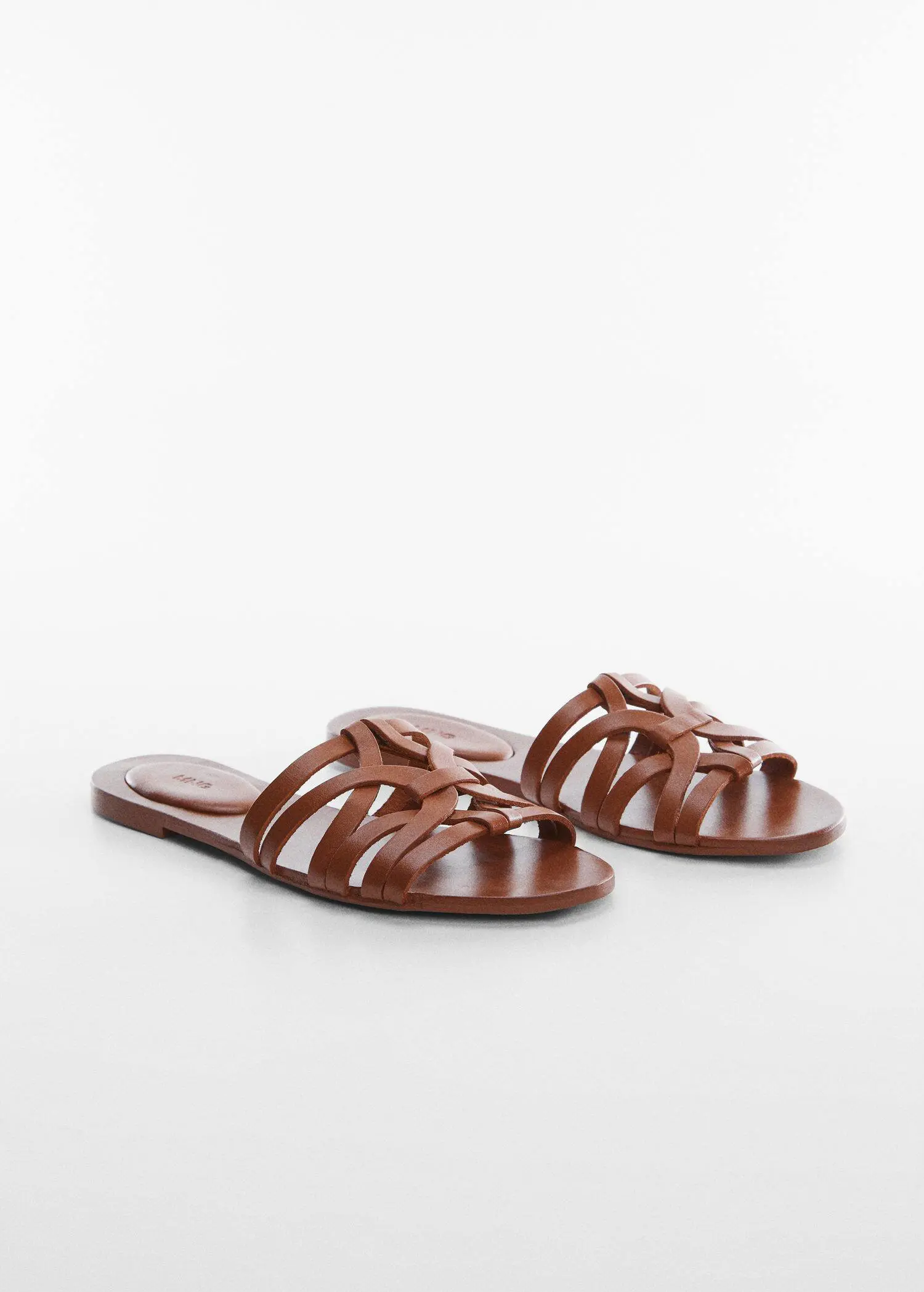 Mango Leather straps sandals. a pair of brown sandals sitting on top of a white surface. 
