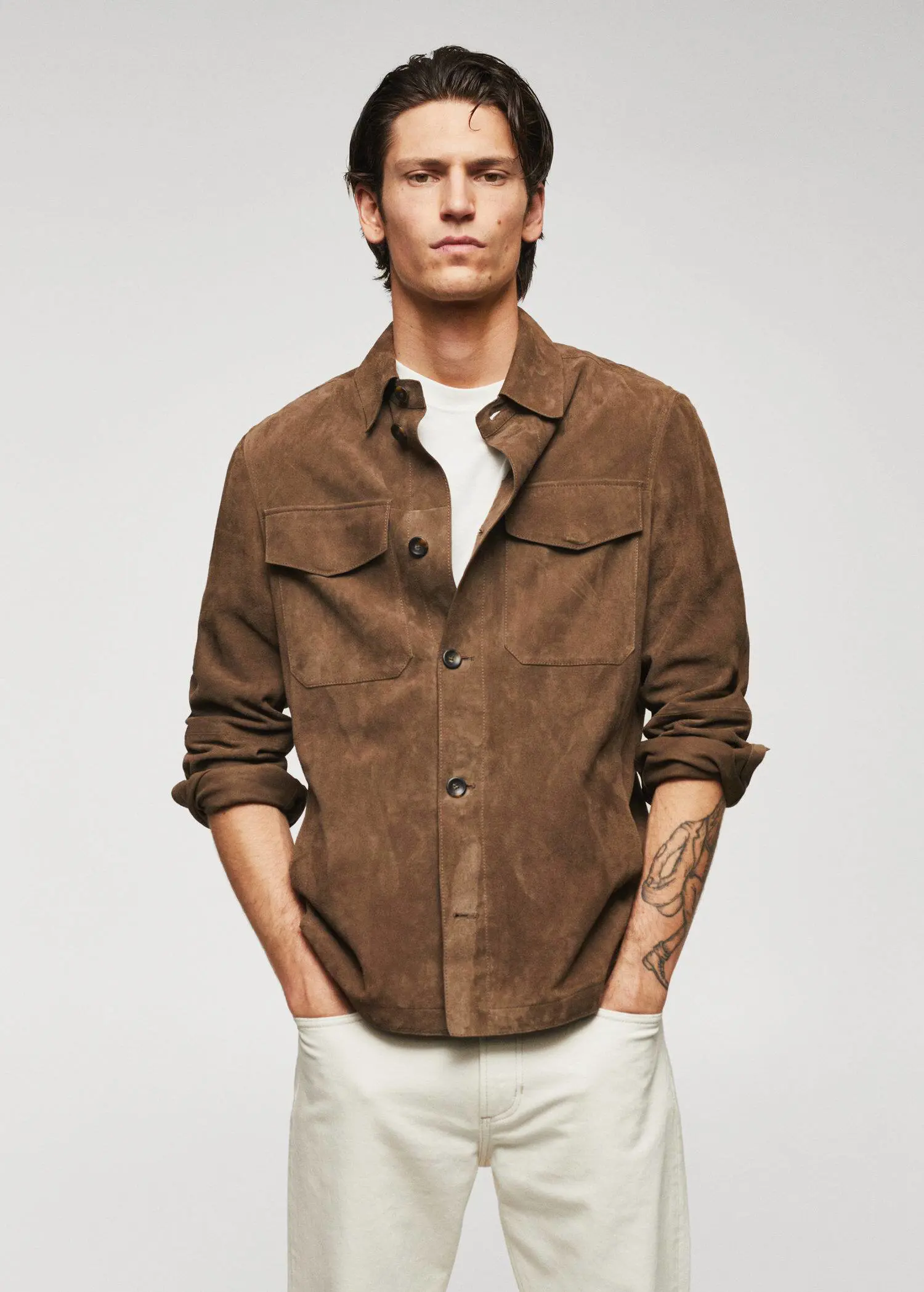 Mango 100% suede leather jacket. a man wearing a brown shirt and white pants. 