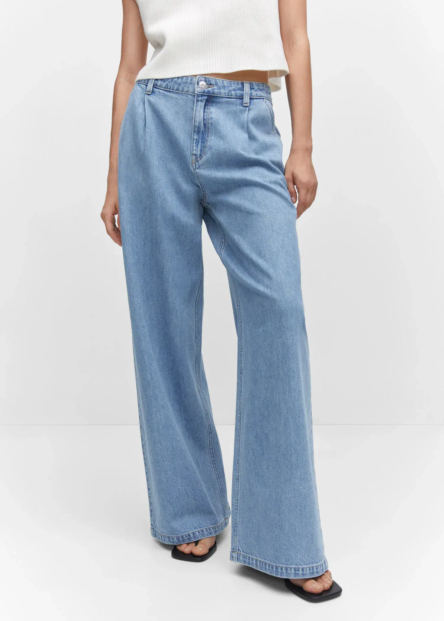 Mango Wide-leg pleated jeans. a person wearing a pair of light blue jeans. 