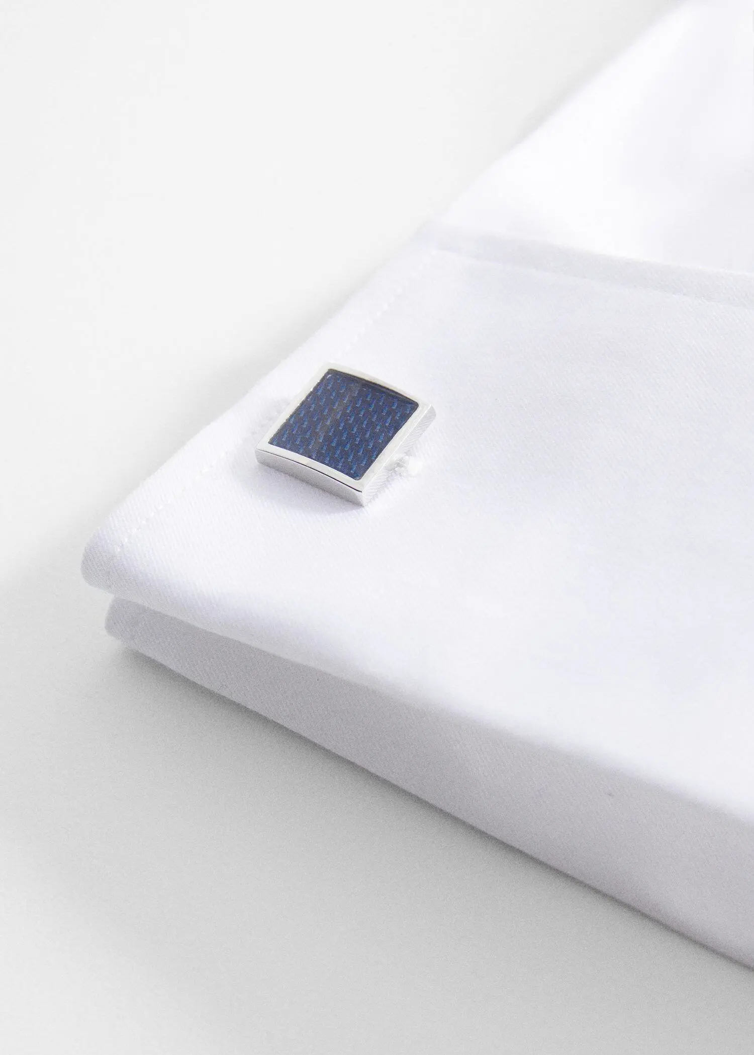 Mango Coloured square cufflinks. a close-up of a solar panel on top of a white sheet. 