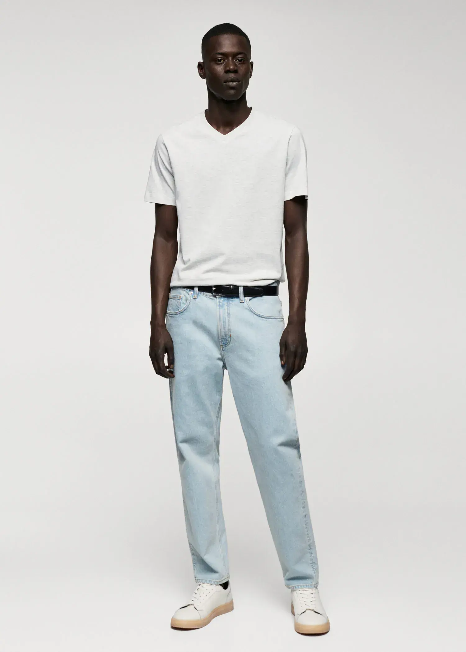 Mango Basic cotton V-neck T-shirt. a man in a white shirt and blue jeans. 