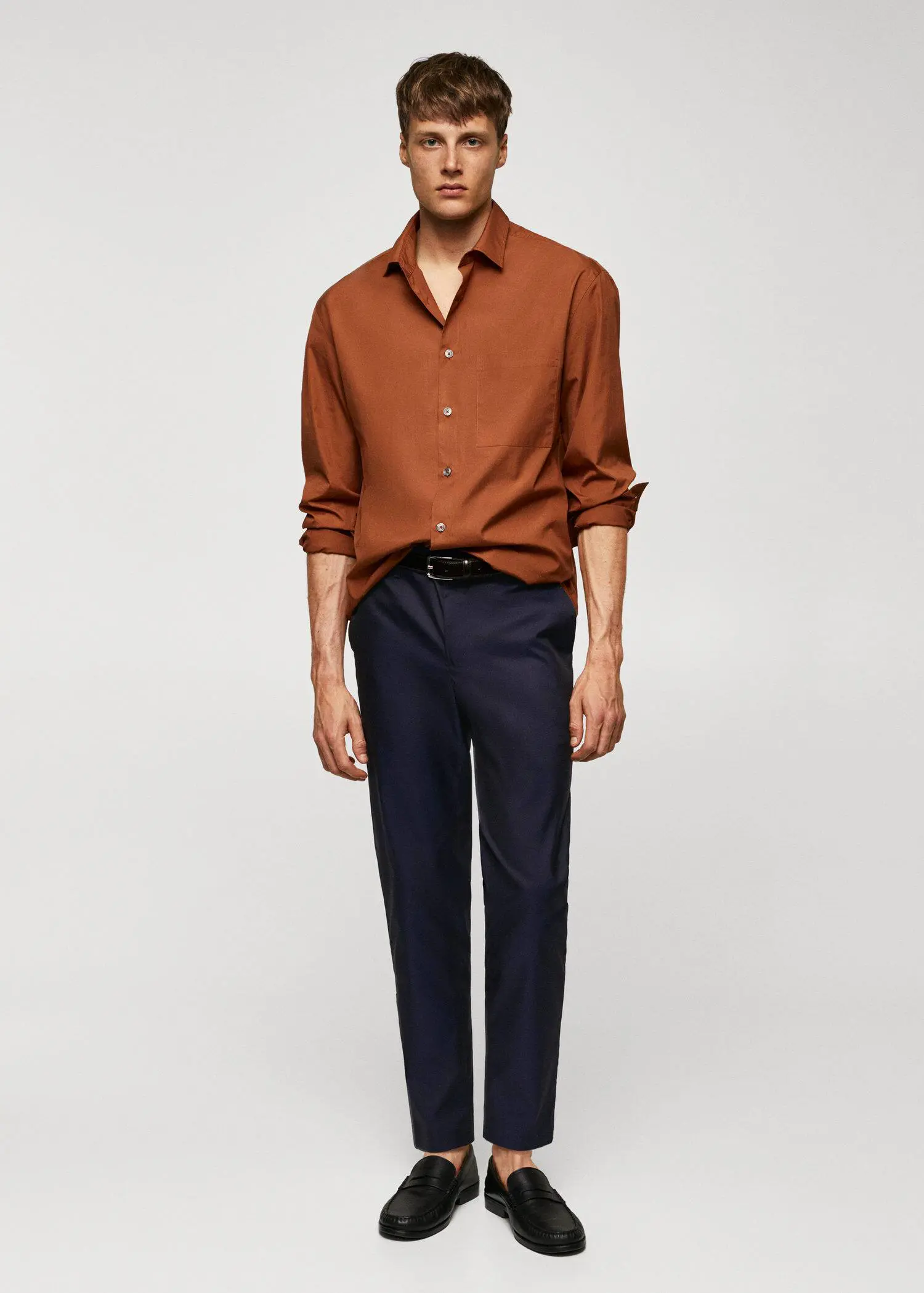 Mango Slim-fit cotton pants. a man wearing a brown shirt and blue pants. 
