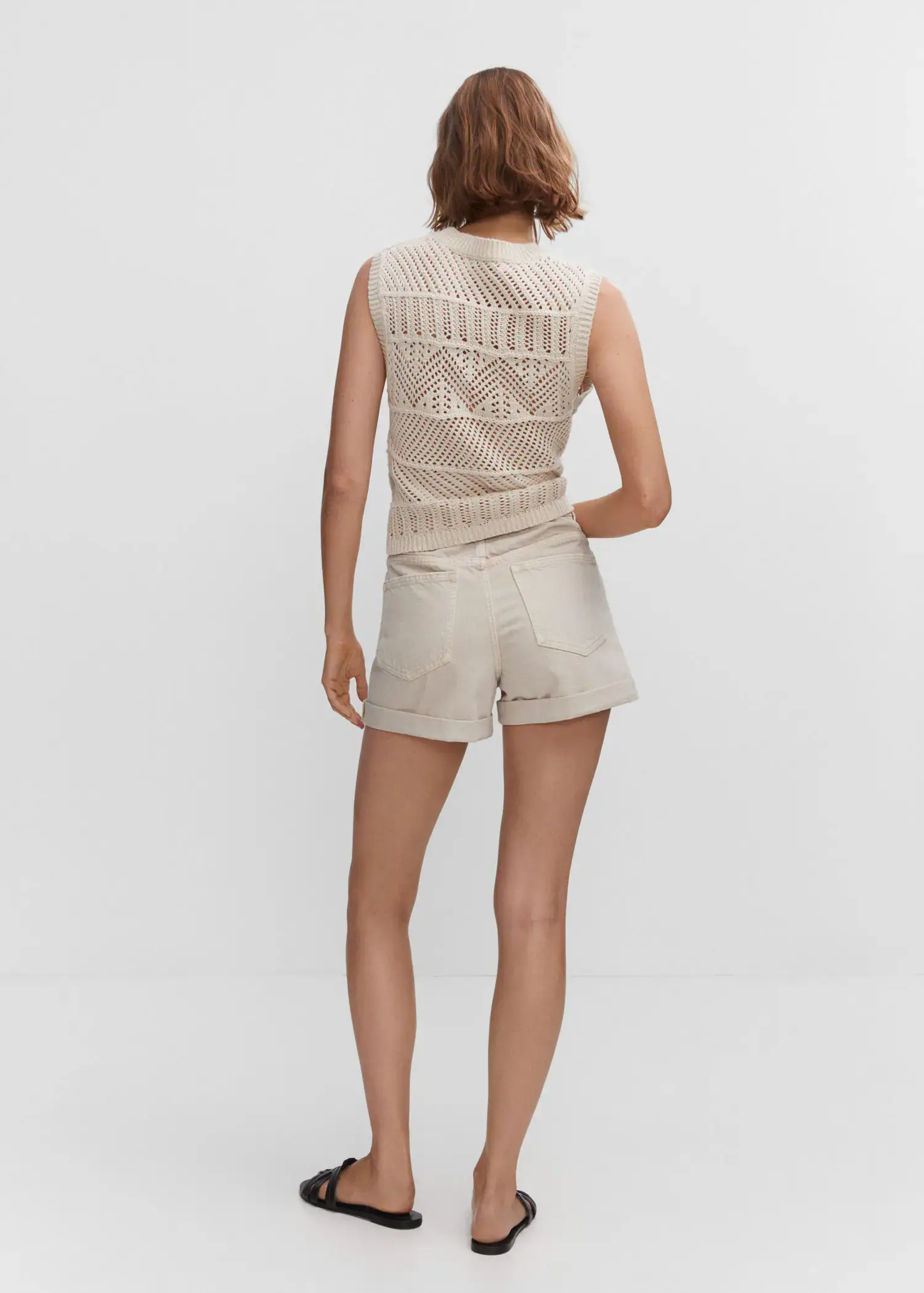 Mango Mom-fit denim shorts. a woman wearing a white top and beige shorts. 