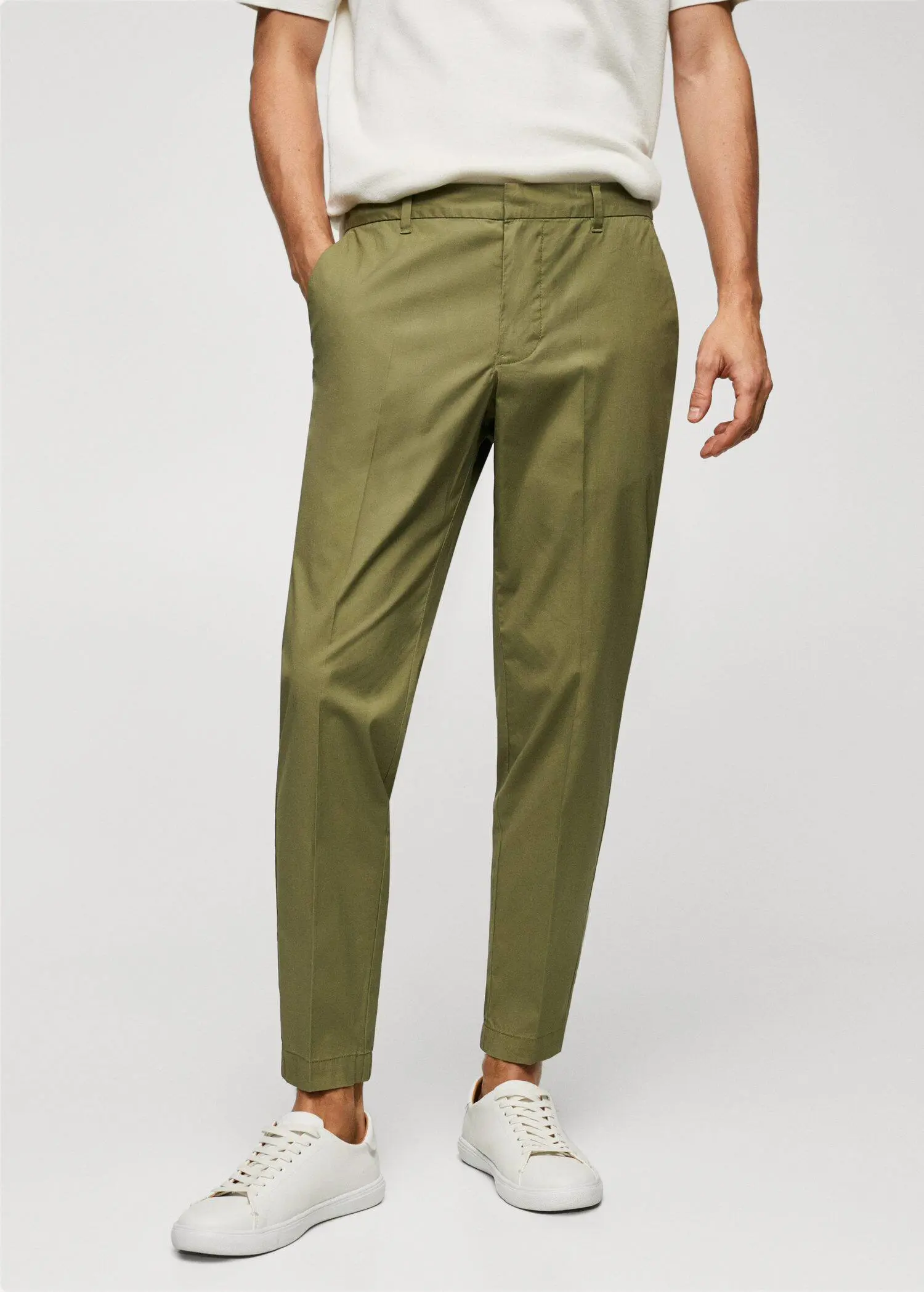 Mango Slim-fit cotton pants. a person wearing a pair of green pants. 