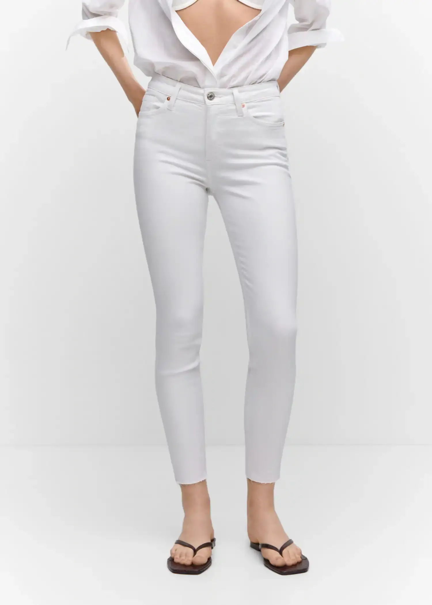 Mango Skinny cropped jeans. a woman is wearing white pants and a white shirt. 