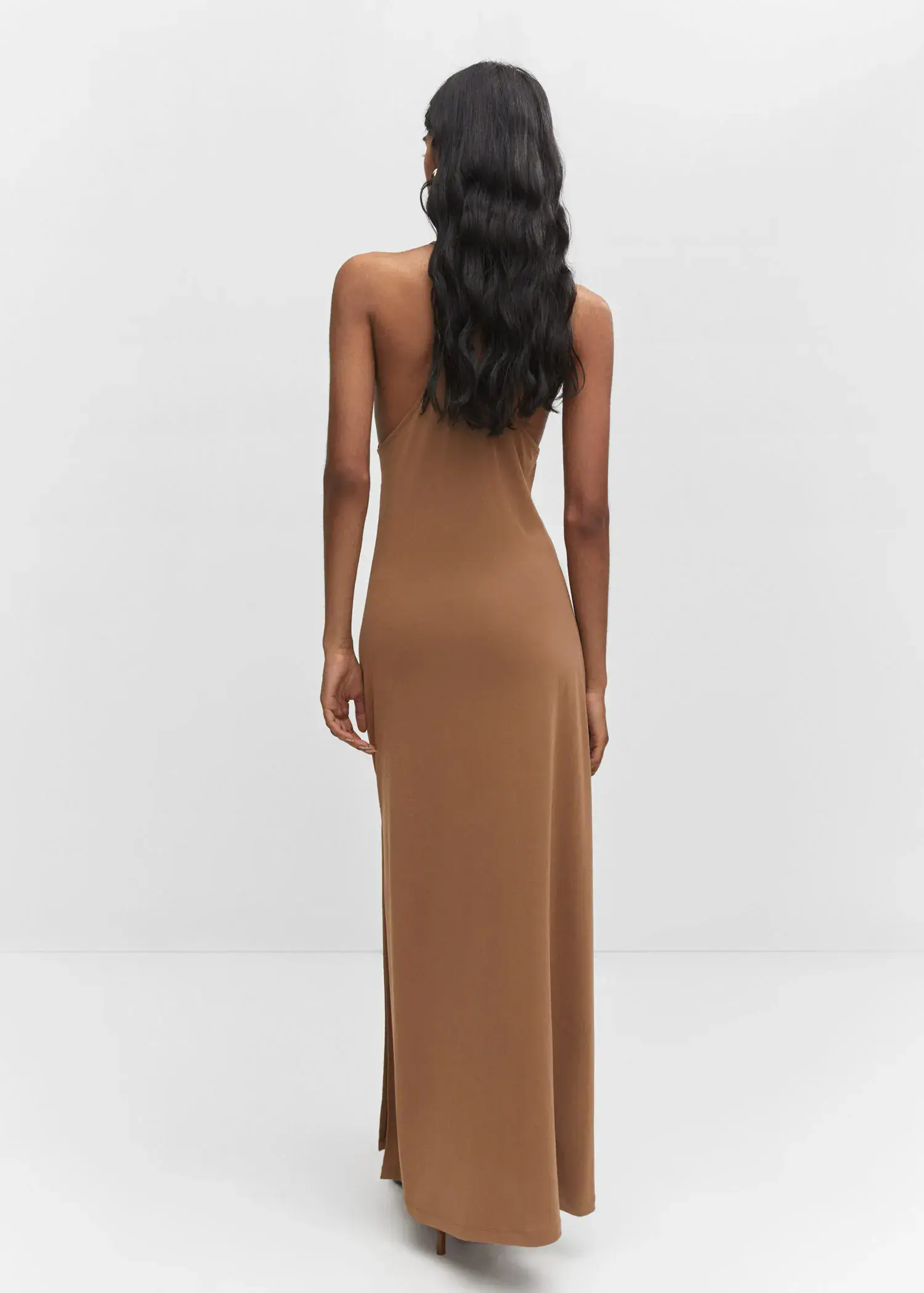 Mango Halter-neck modal dress. a woman in a tan dress standing in front of a wall. 