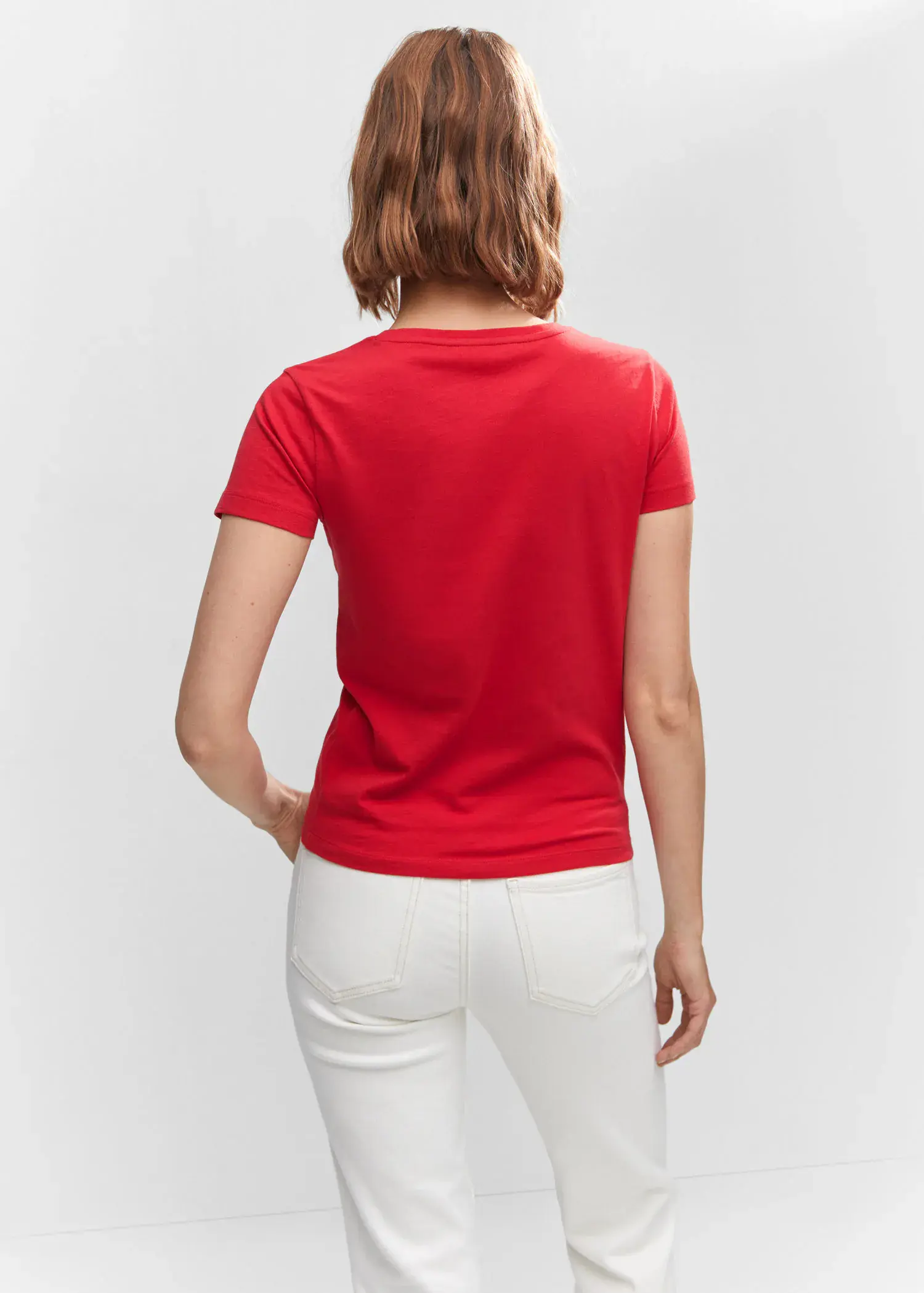 Mango Metallic logo T-shirt. a woman in a red shirt and white pants. 