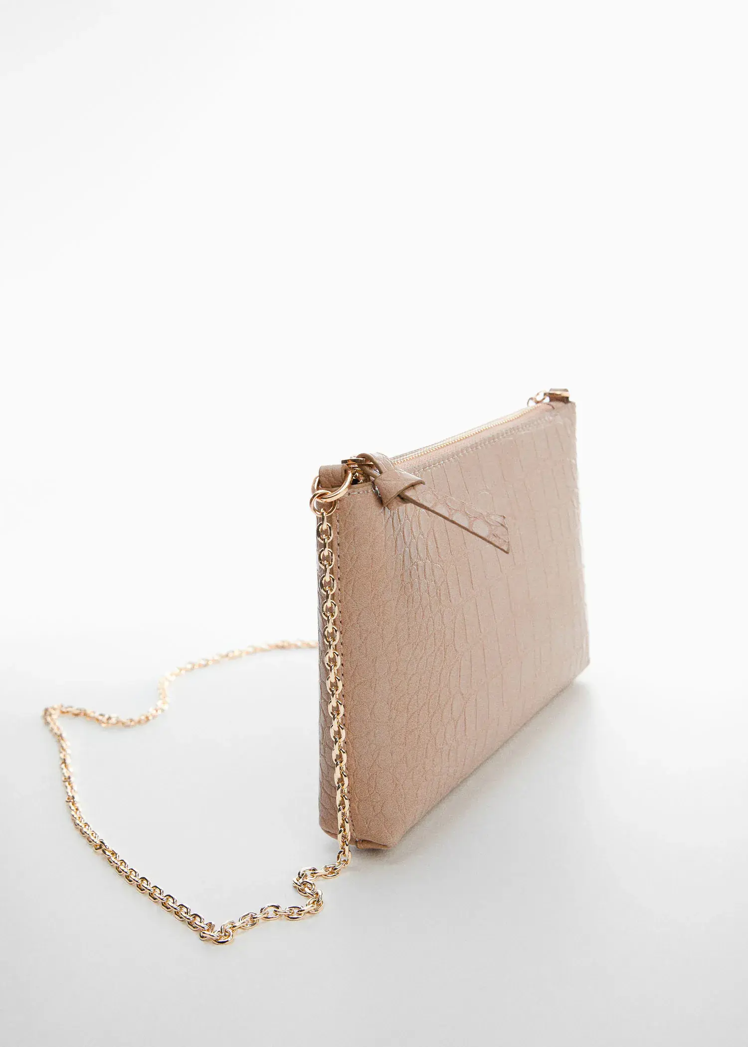Mango Coco chain bag. a beige purse with a gold chain on a table. 