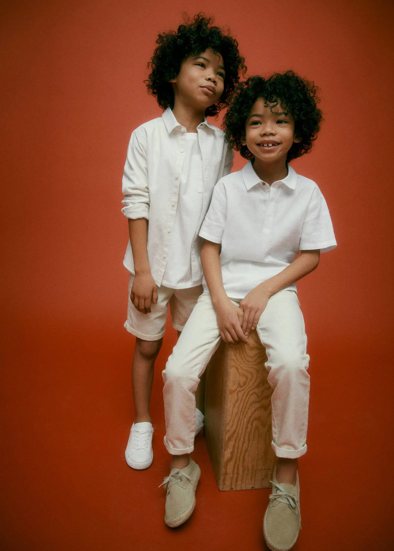 Mango KIDS/ Linen chinos. two young boys in white shirts and white shorts. 