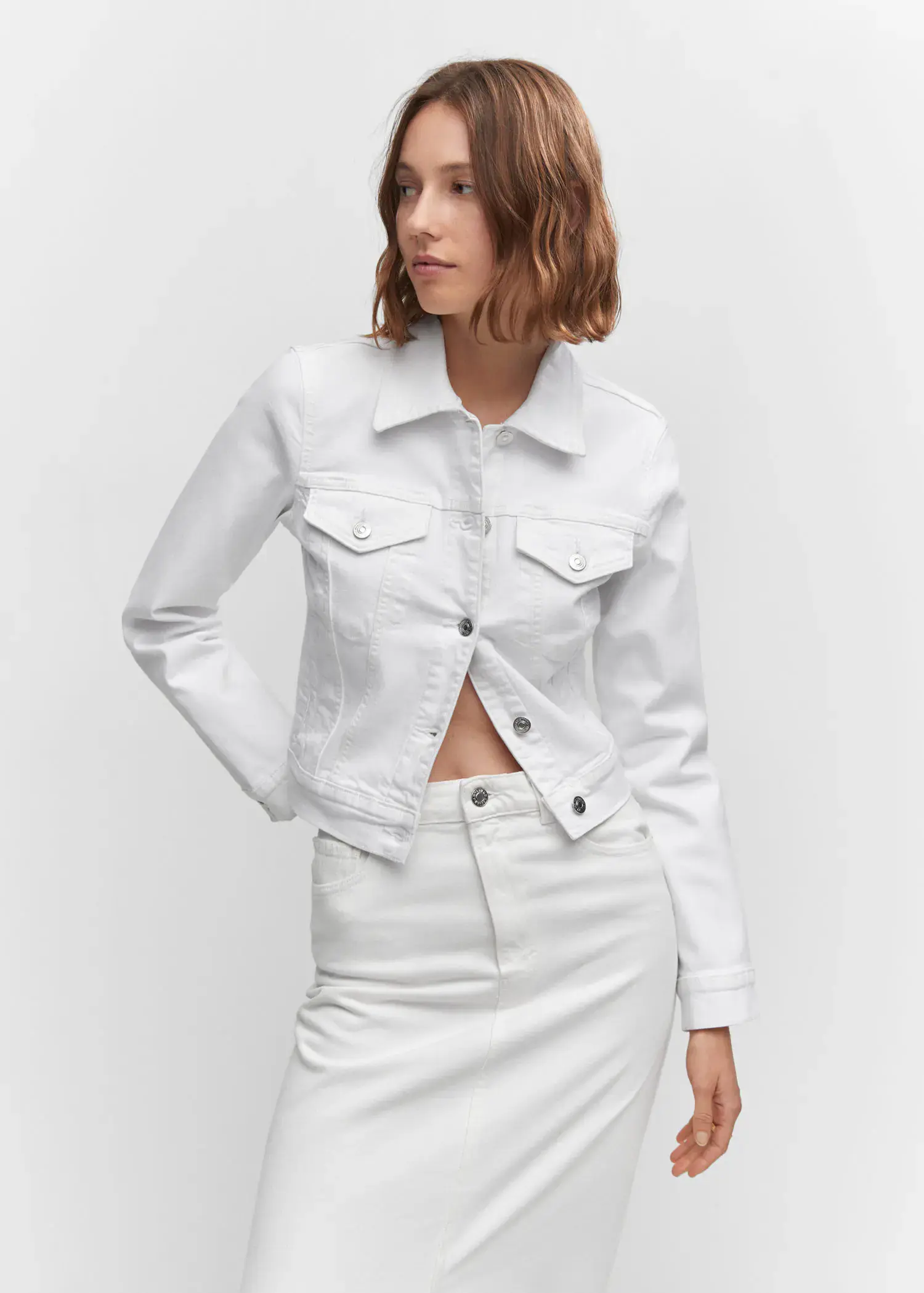 Mango Pocketed denim jacket. a woman wearing a white jacket and a white skirt. 