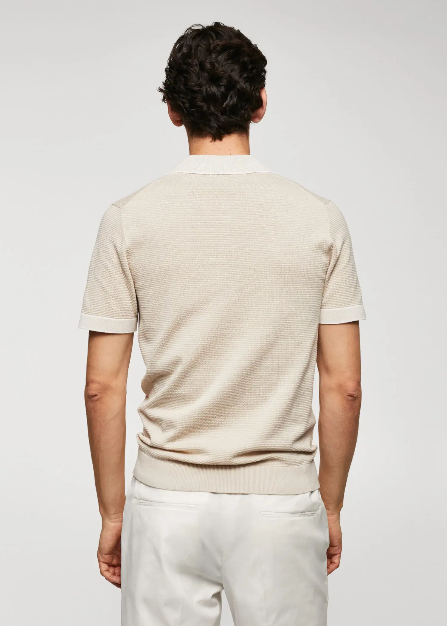 Mango Fine-knit polo shirt with zip. a man wearing a white shirt and a beige shirt. 