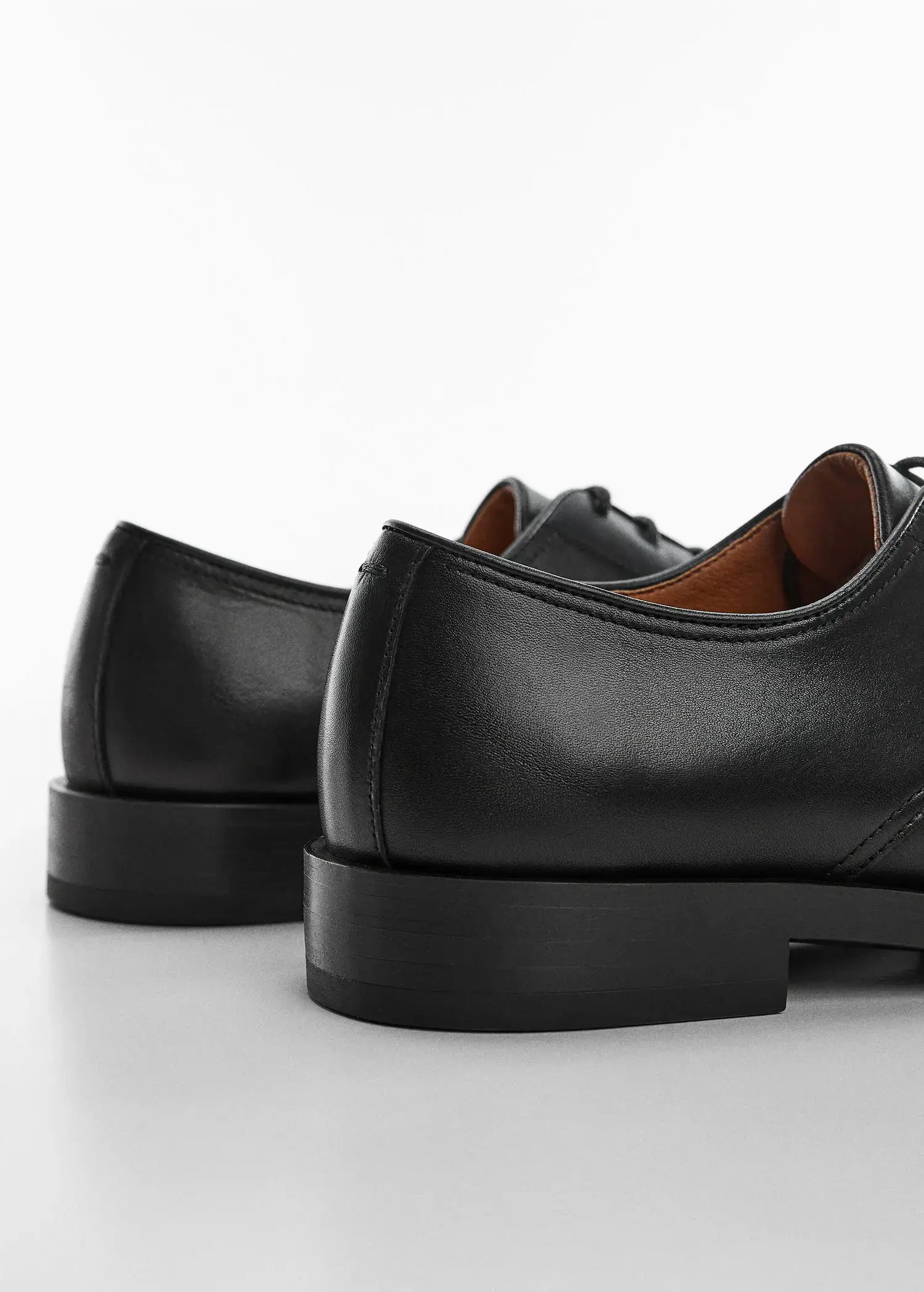 Mango Leather suit shoes. a close up of a pair of black shoes. 