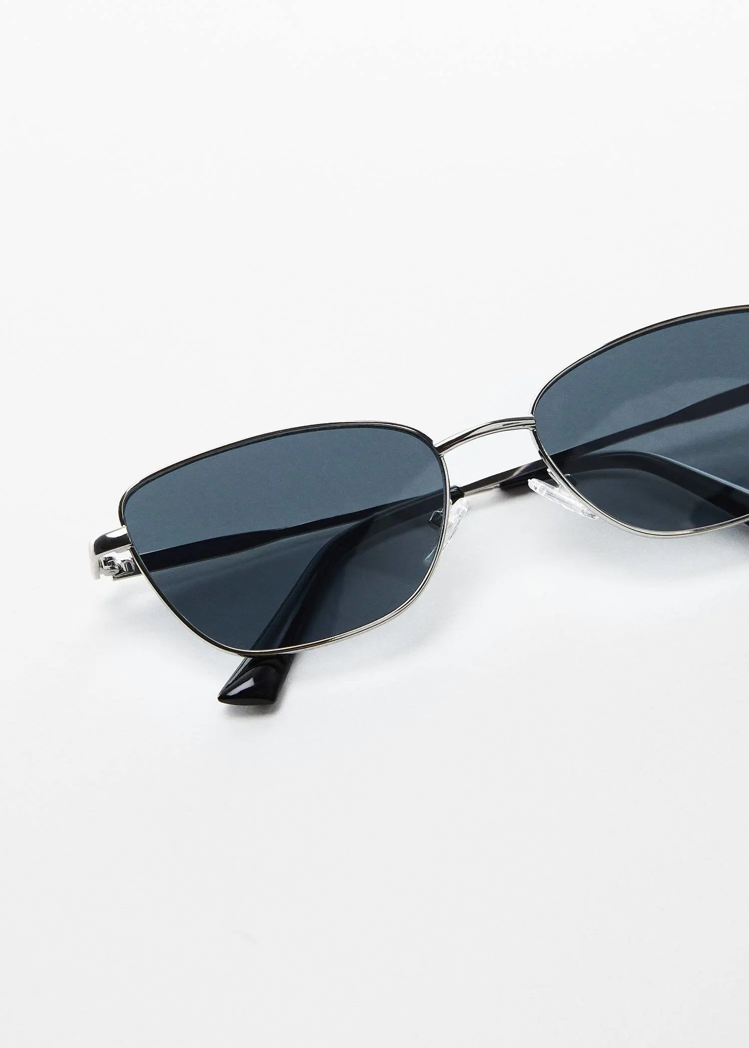 Mango Metal bridge sunglasses. a close up of a pair of sunglasses on a table 