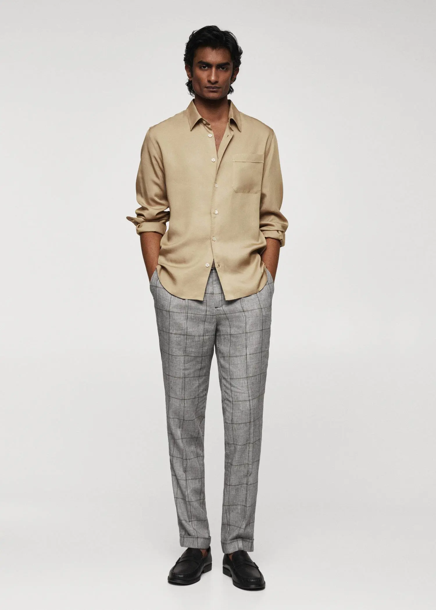 Mango Prince of Wales linen-blend trousers. a man in a tan shirt and gray pants. 