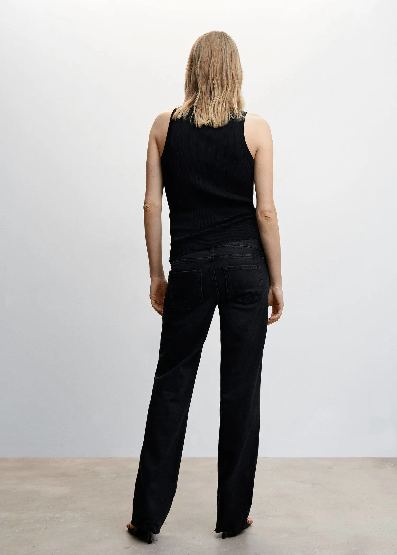 Mango Maternity wideleg jeans. a woman in a black top and black pants. 