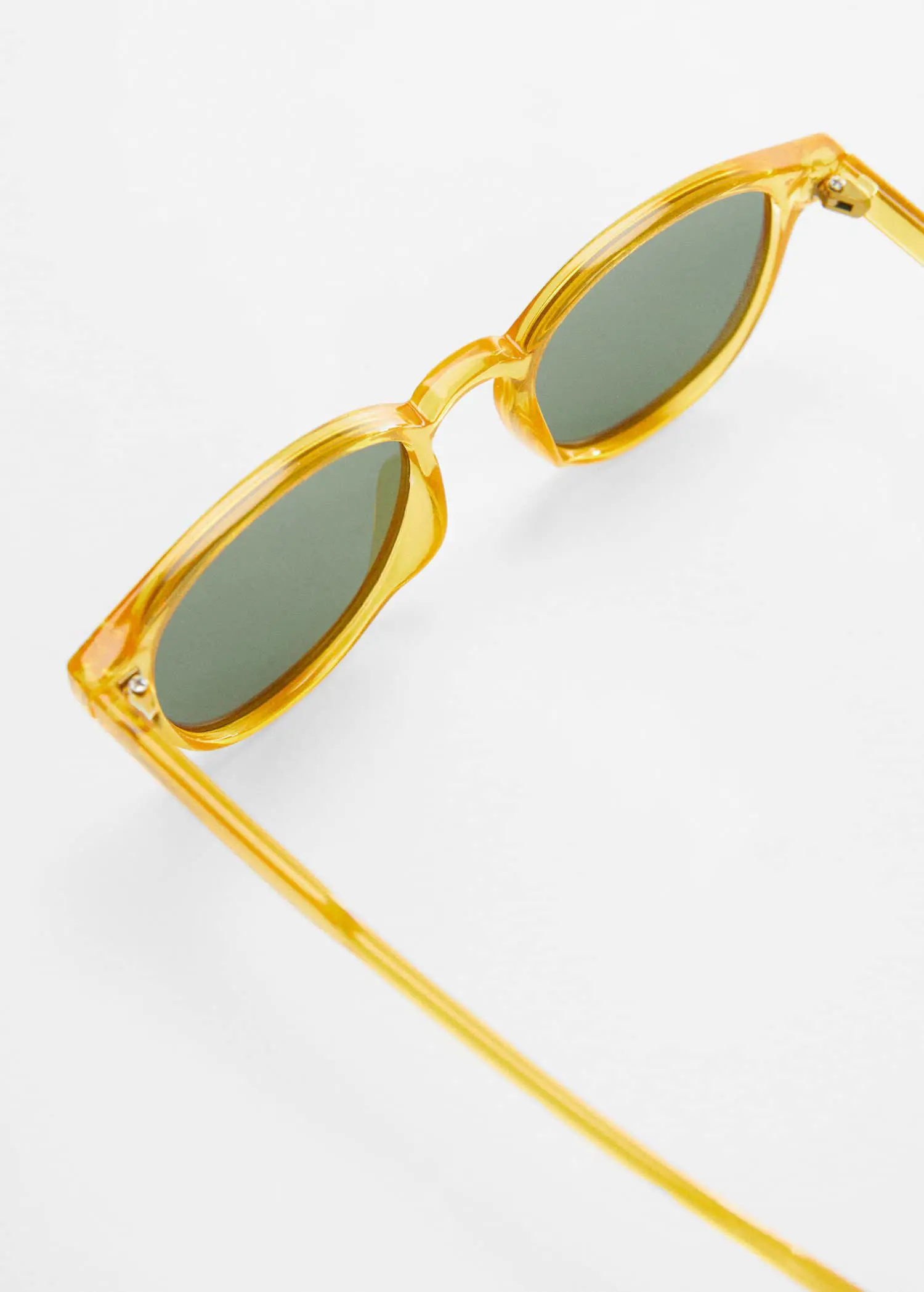 Mango Polarised sunglasses. a close up of a pair of glasses on a white surface 