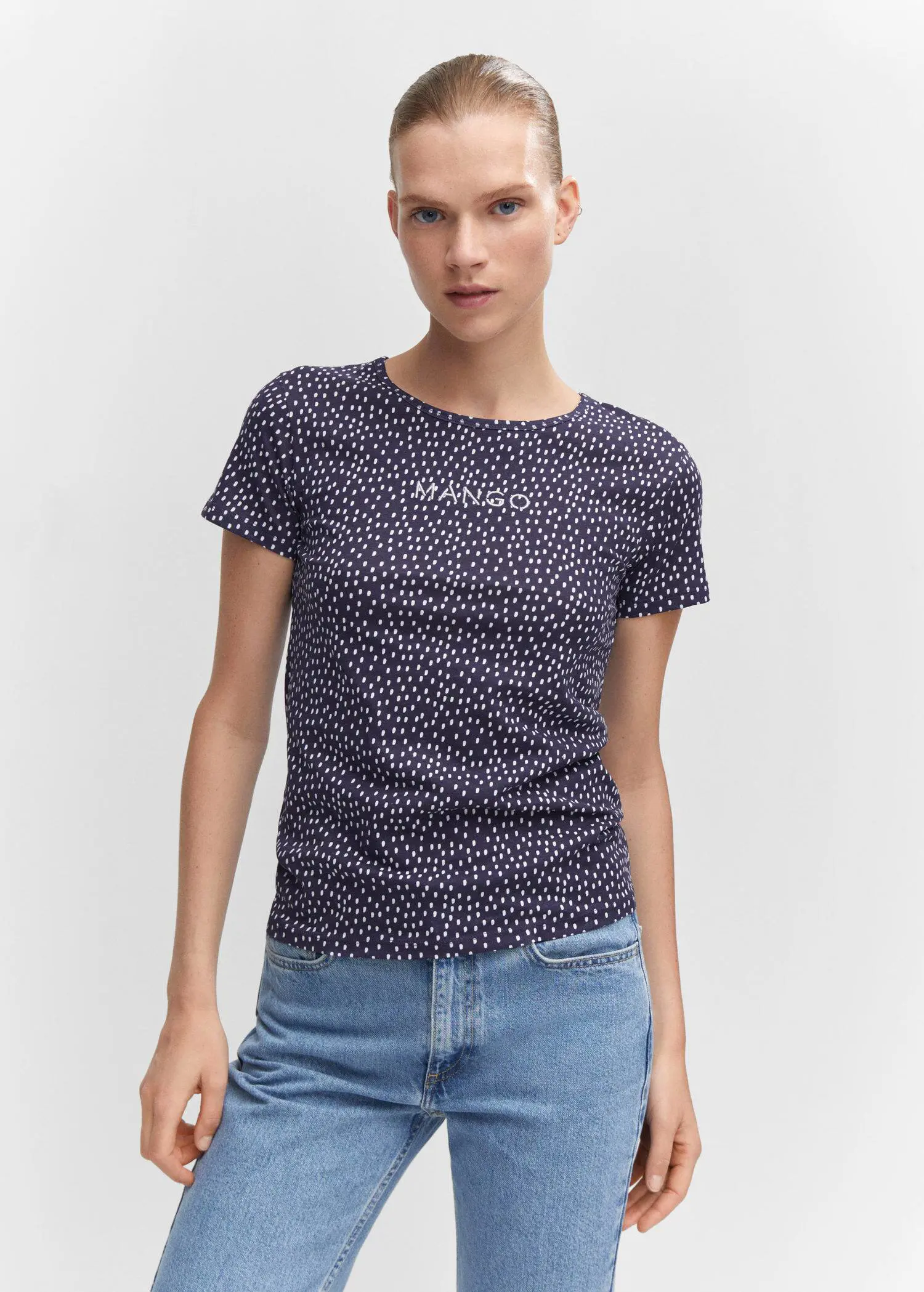 Mango Embroidered logo print t-shirt. a woman wearing a t-shirt and jeans. 