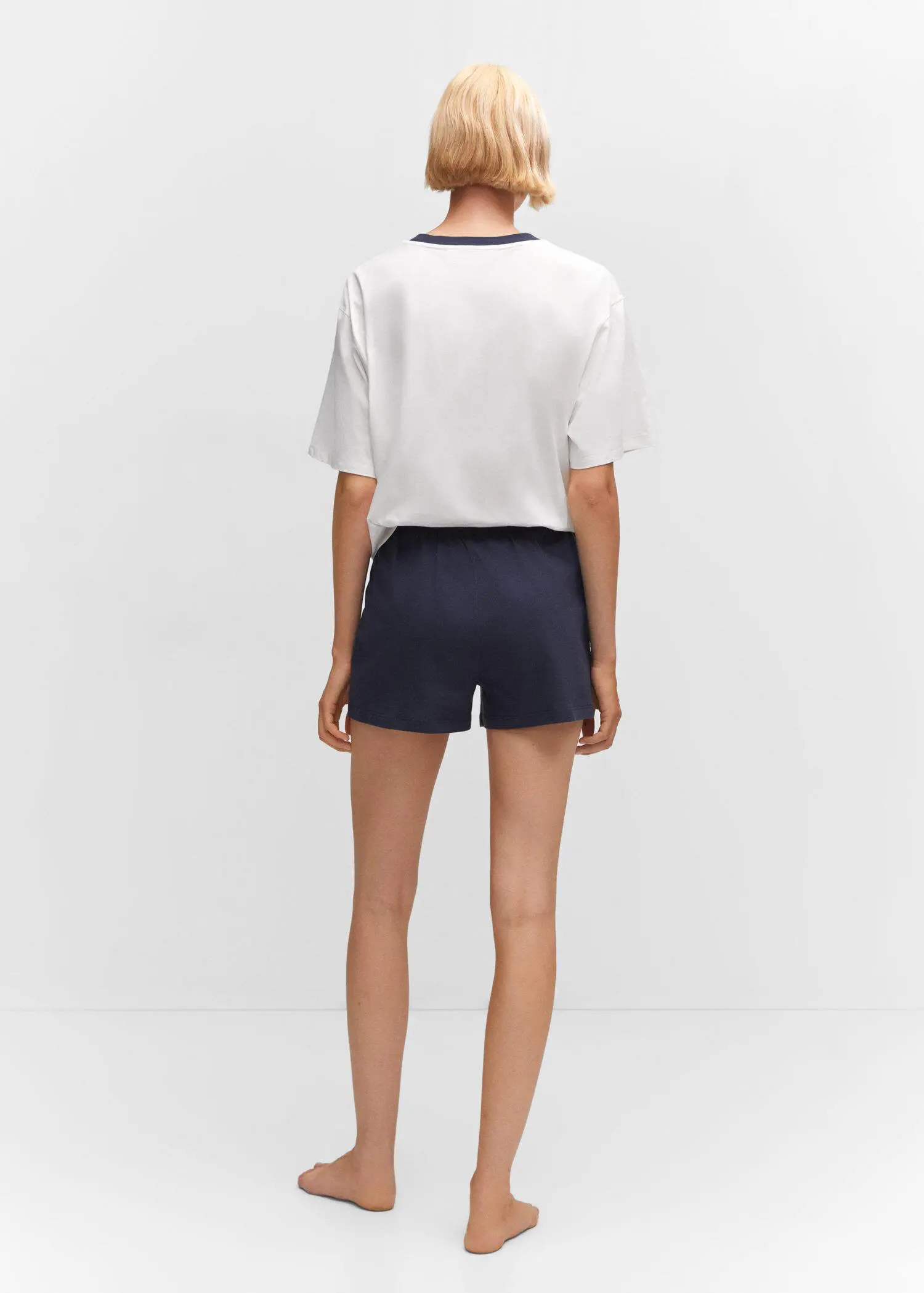 Mango Cotton shorts with elastic waist. a person wearing a white shirt and black shorts. 