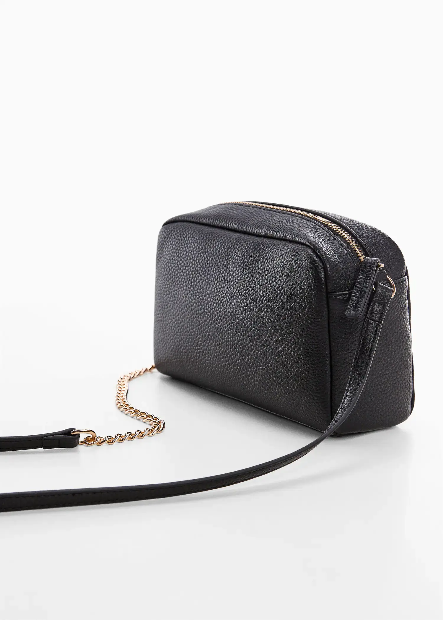 Mango Crossbody bag with chain. a black purse with a gold chain on a table. 