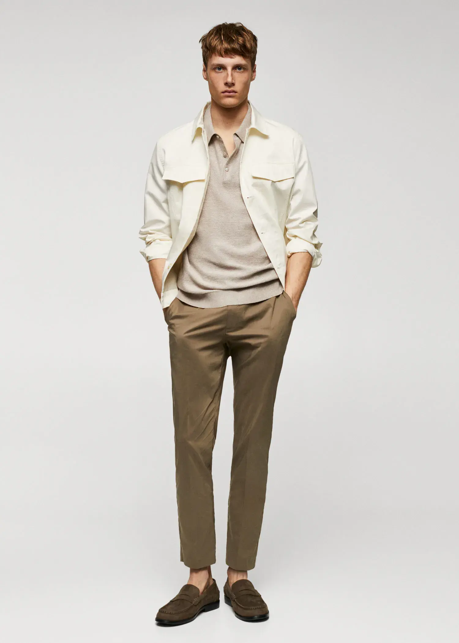 Mango Patterned cotton polo shirt. a man in a beige shirt and a white jacket. 