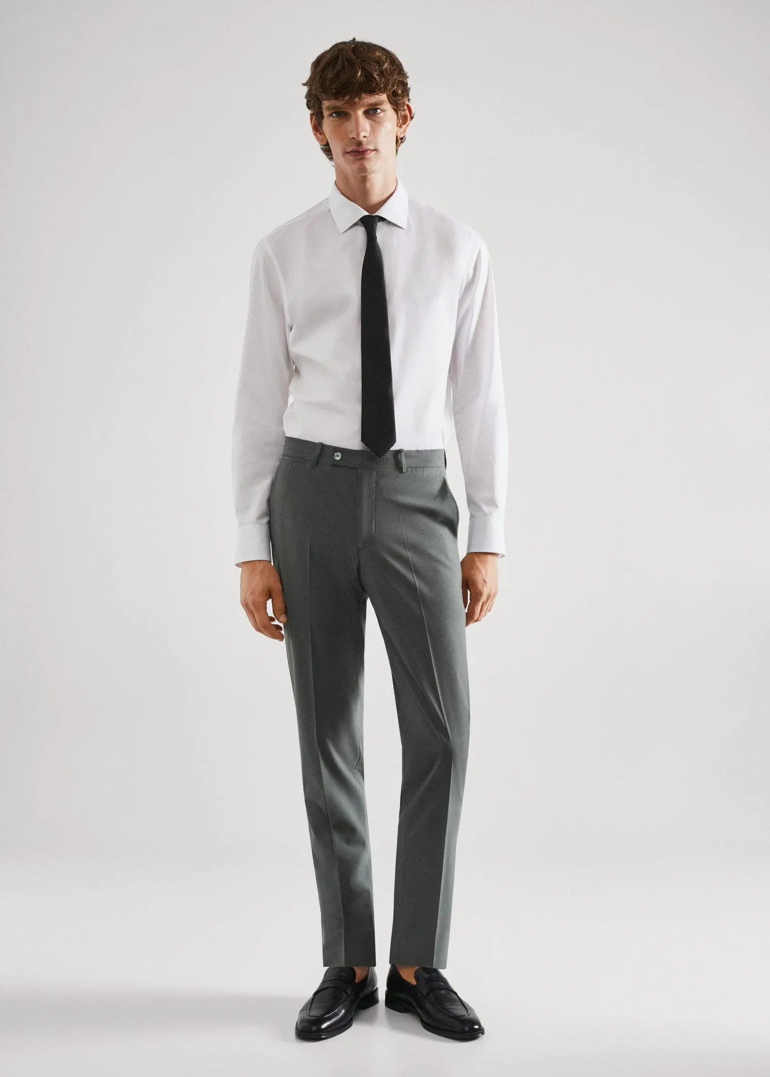Mango Wool slim-fit suit trousers. a man in a white dress shirt and black tie. 
