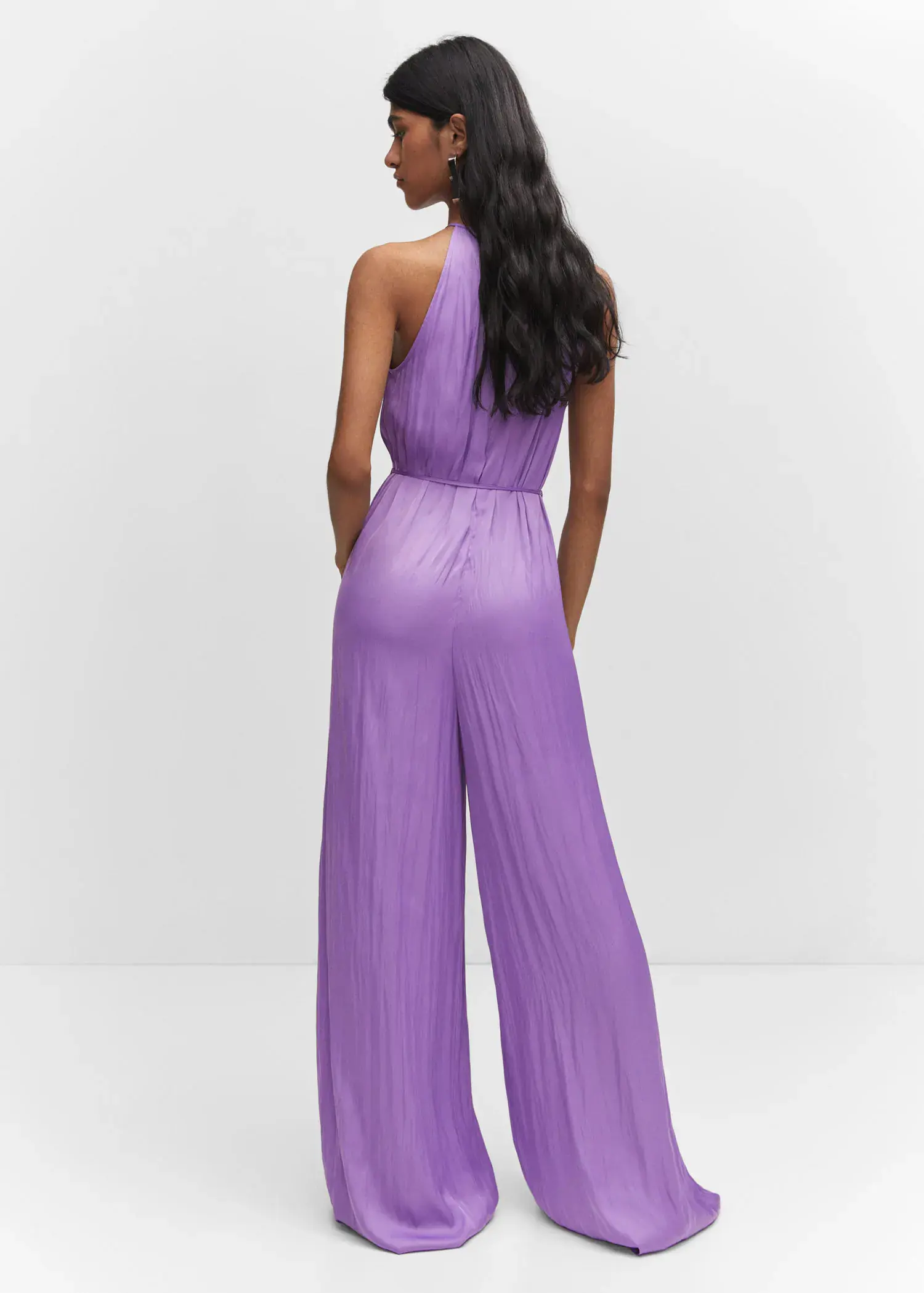Mango Halter-neck satin jumpsuit. a woman wearing a purple jumpsuit standing in front of a wall. 